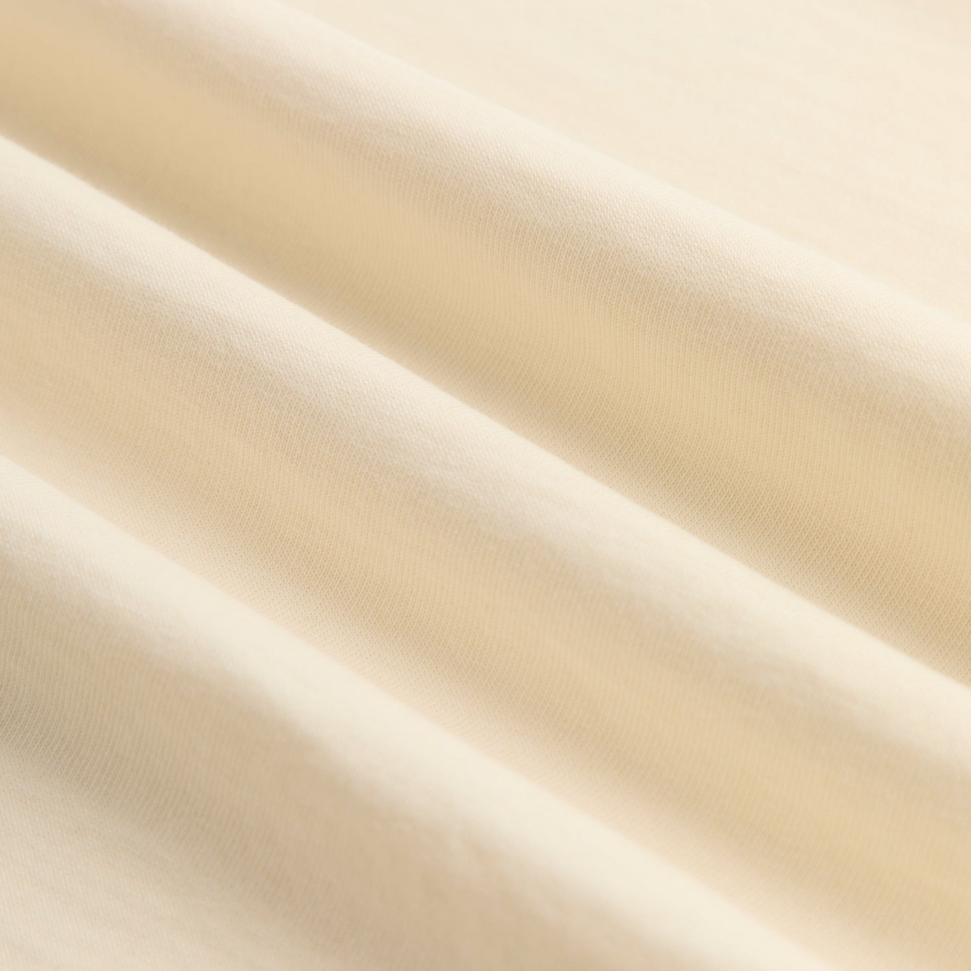 Close-up of the Kith Baby Leopard Kith Serif Leonard Tee's cream cotton jersey fabric