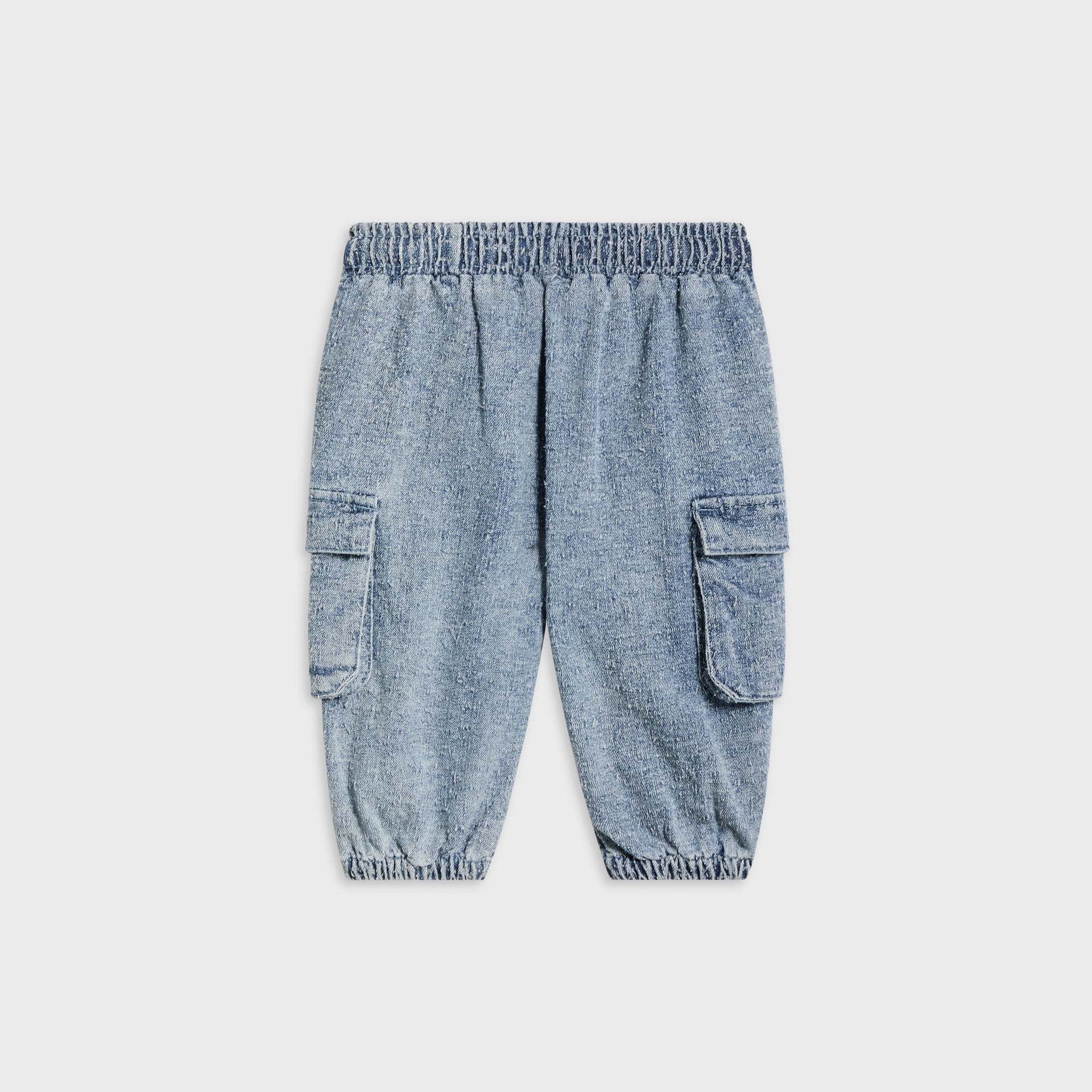 Kith Baby Textured Denim Chauncey Pant in Indigo, flat lay back view showing elastic cuffed ankles