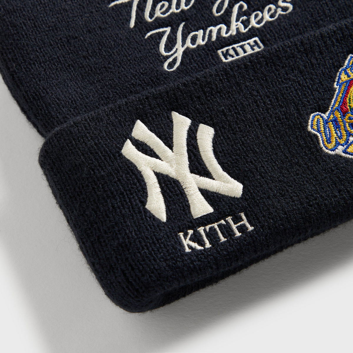 Kith Baby & '47 for the New York Yankees acrylic beanie in Nocturnal navy, flat lay showing New York to the World embroidery and Yankees patches on the cuff