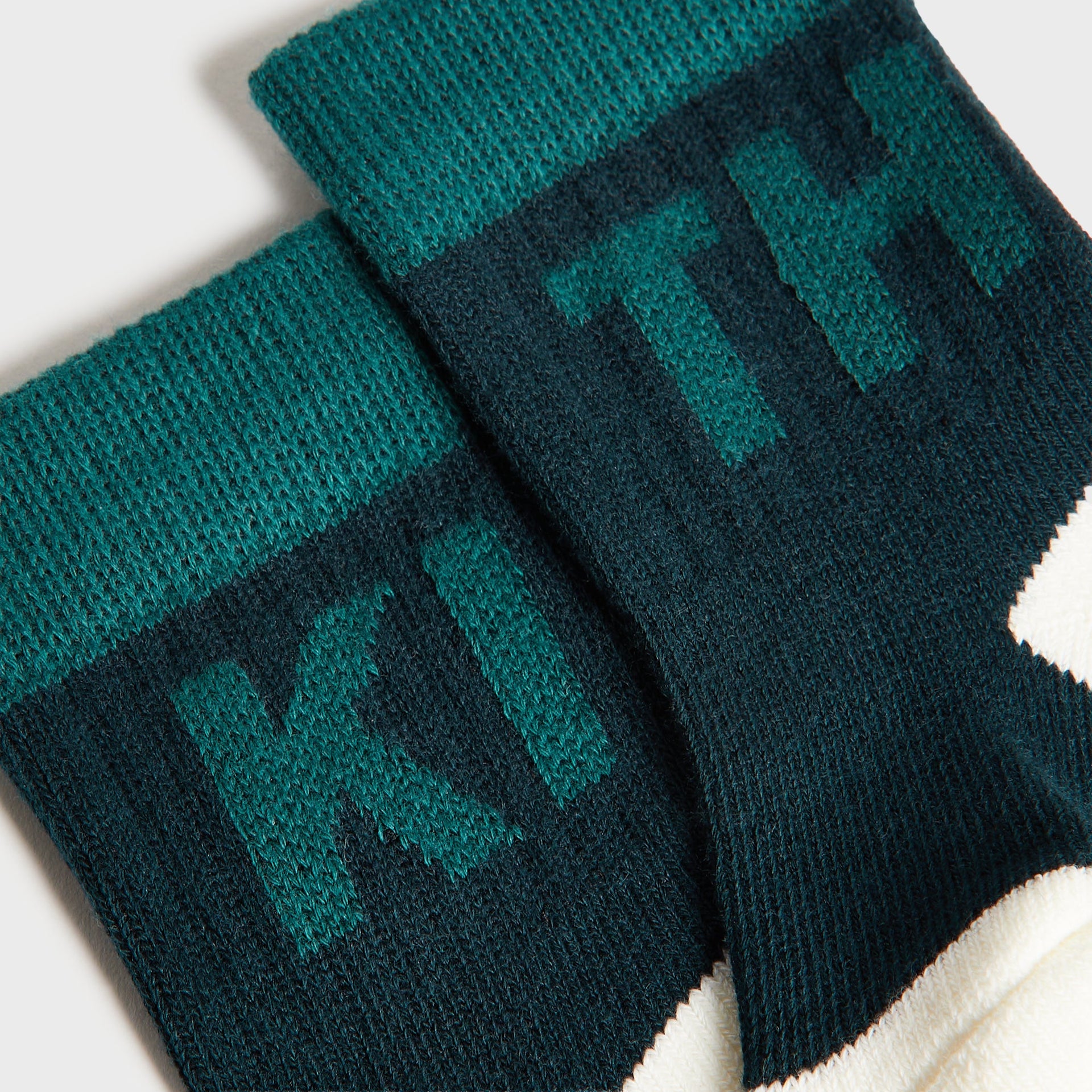Kith Baby Color-Blocked Crew Socks, close-up of teal green and navy cuffs with tonal KITH jacquard lettering