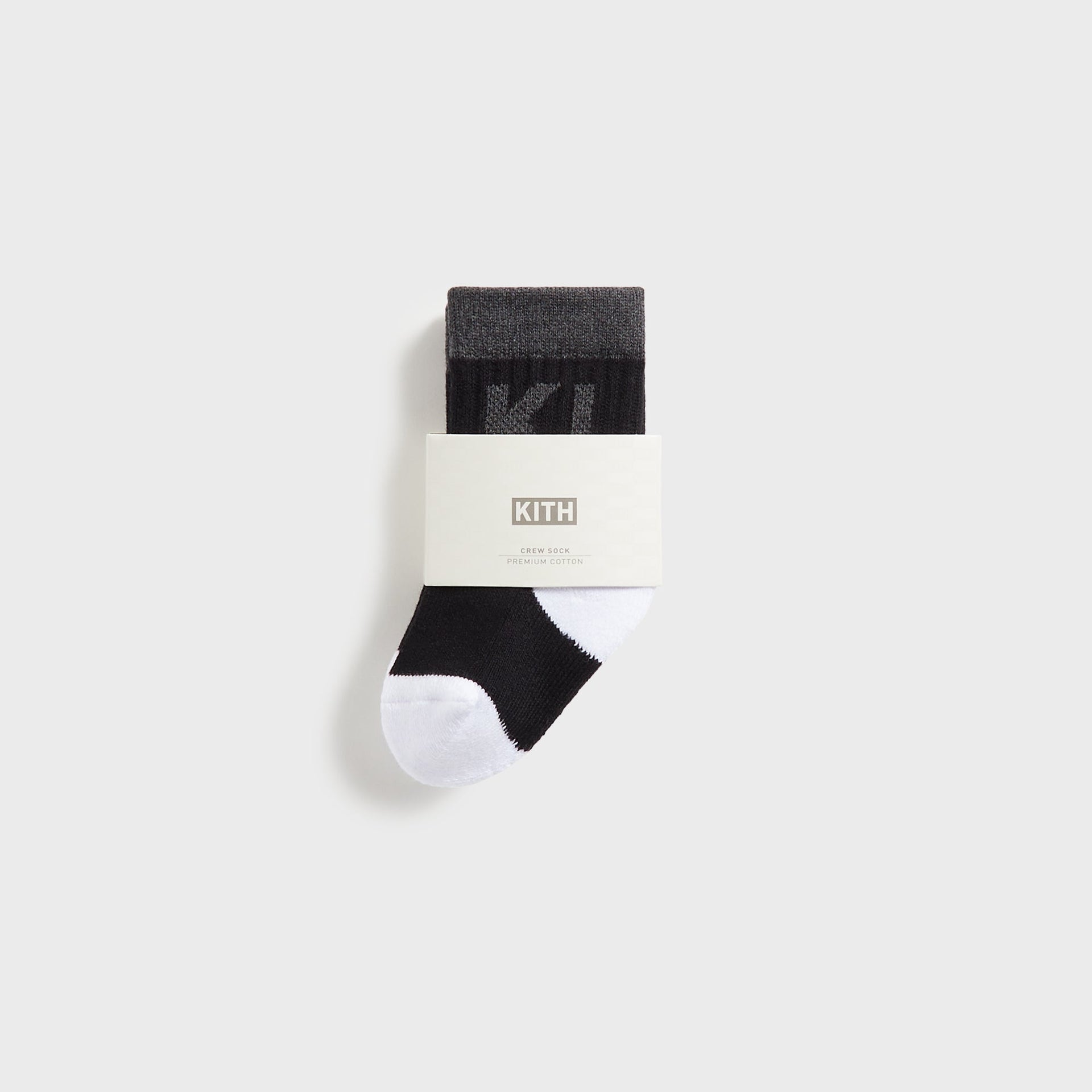 Kith Baby Color-Blocked Crew Socks, single black and grey crew sock in branded KITH premium cotton packaging band