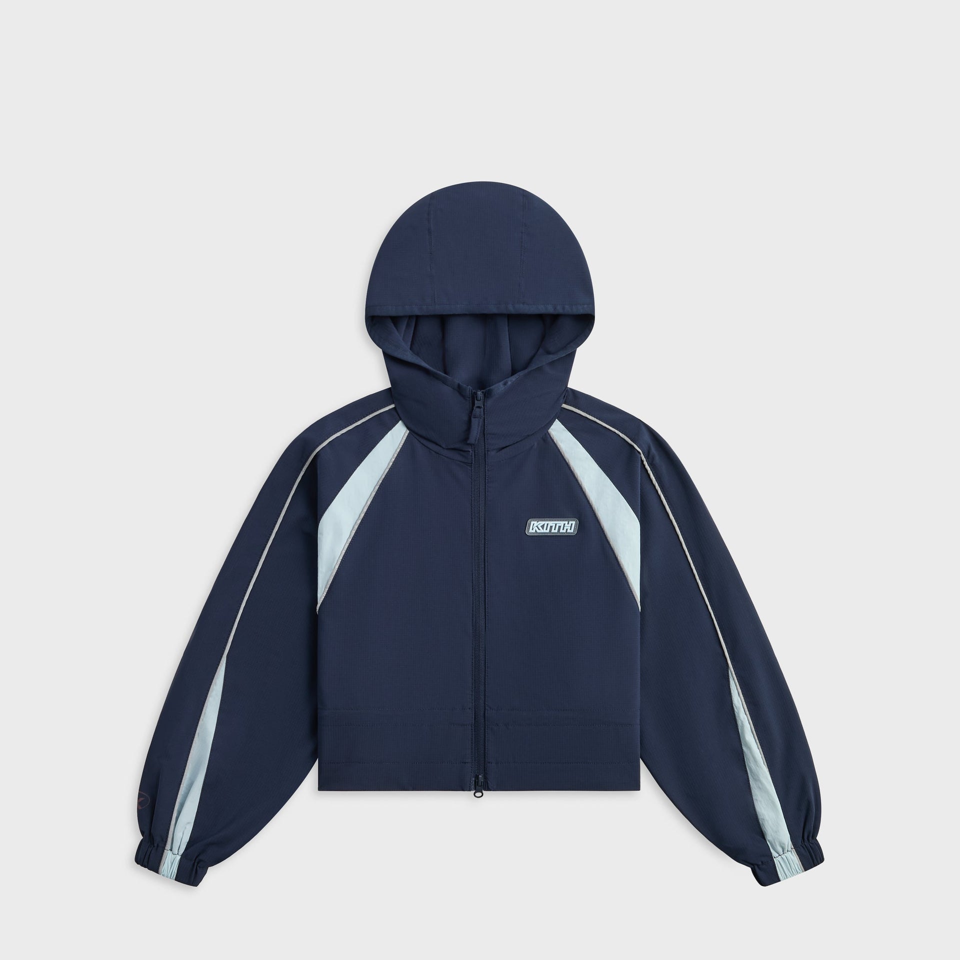 Kith Kids Lora Windbreaker Jacket in navy, front view with hood, full zip, light blue panels and KITH chest patch