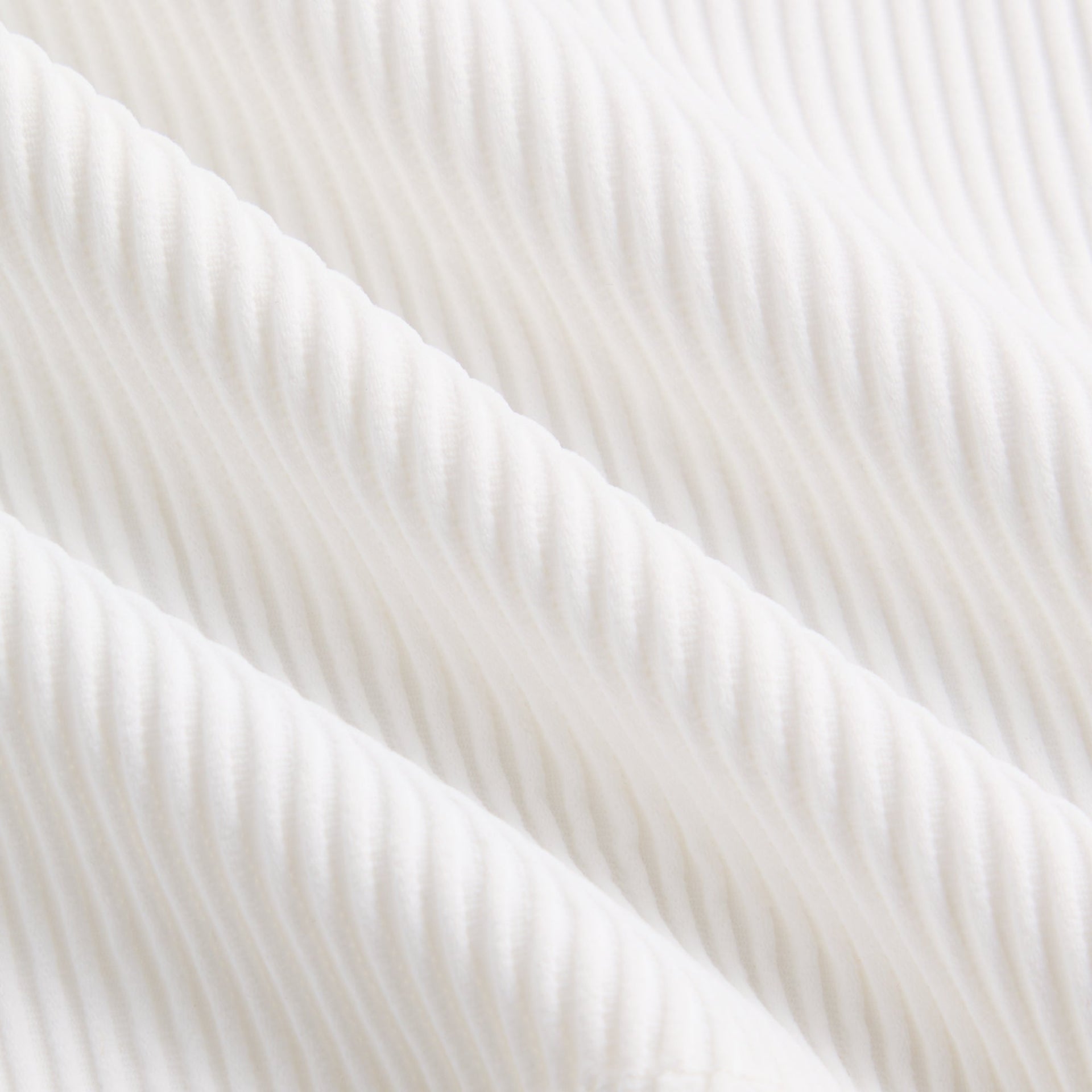 Kith Kids Active Fairway Polo in white, macro close-up of ribbed knit fabric texture