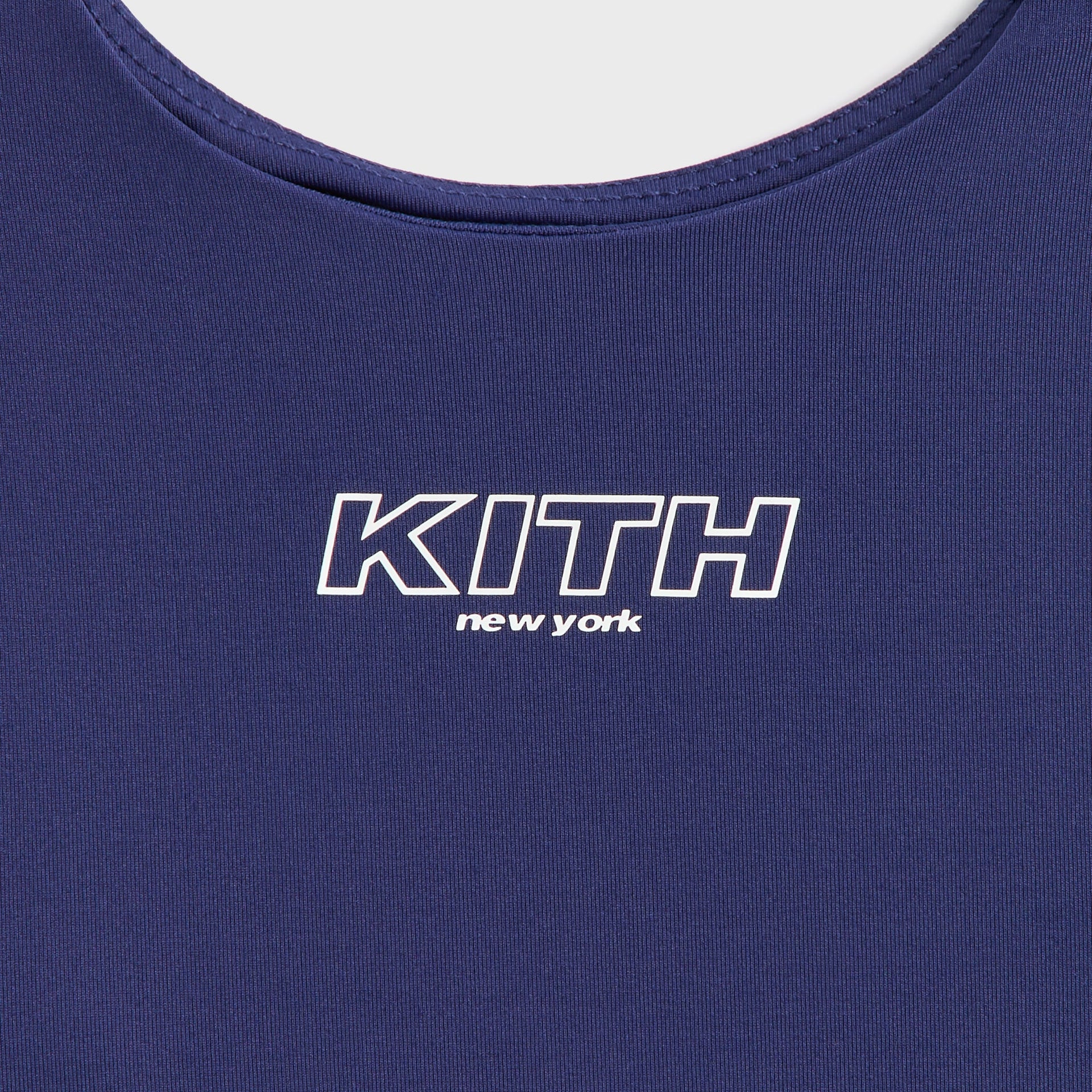 Close-up of Kith Kids Active Zamira Tank in Nocturnal navy showing scoop neck and KITH New York front logo