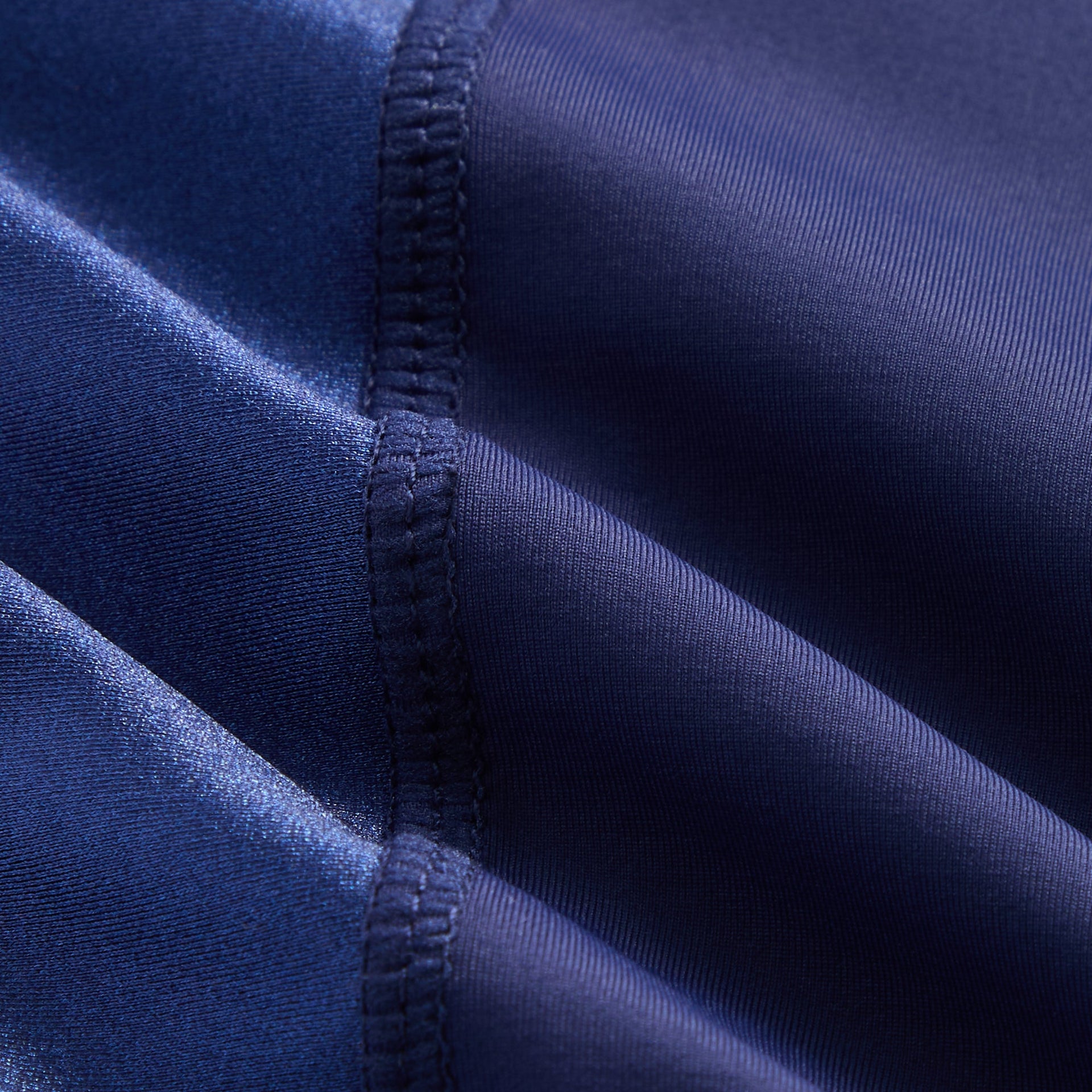 Fabric detail of Kith Kids Active Zamira Tank in Nocturnal navy showing glossy side panels and seams