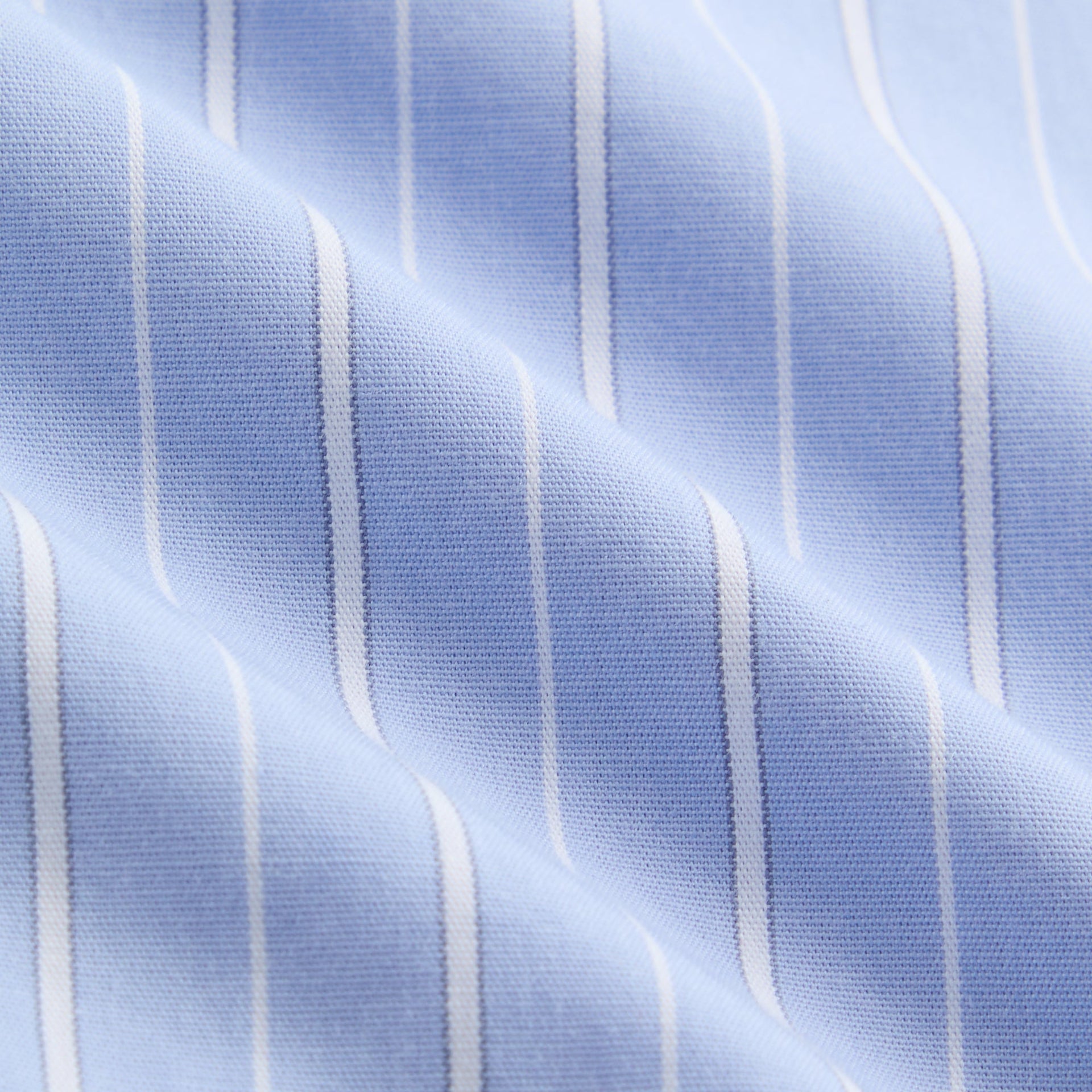 Close-up of the light blue and white pinstripe cotton fabric of the Kith Kids Berkeley shirt