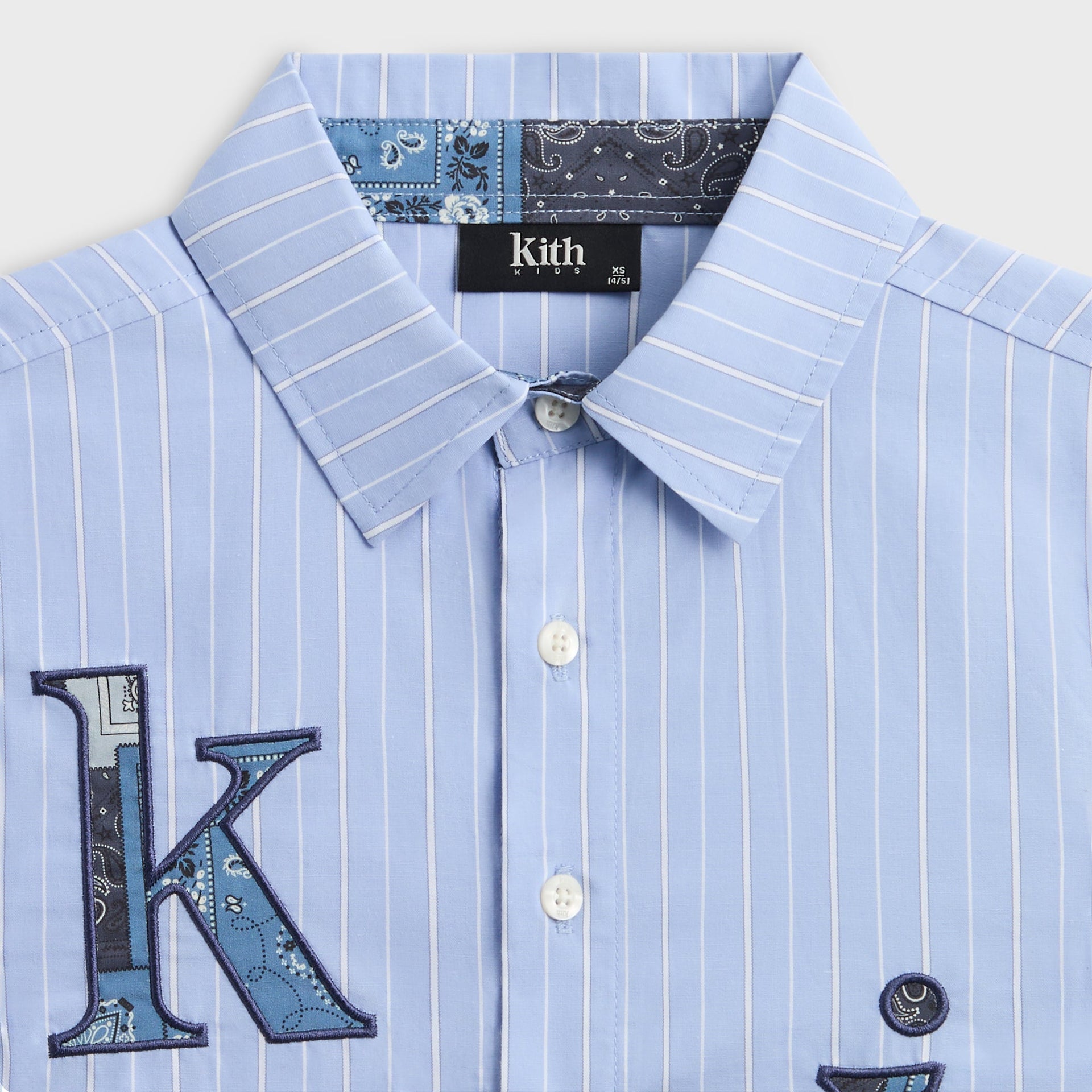 Close-up of the collar with bandana paisley inner trim and applique K on the Kith Kids Berkeley shirt