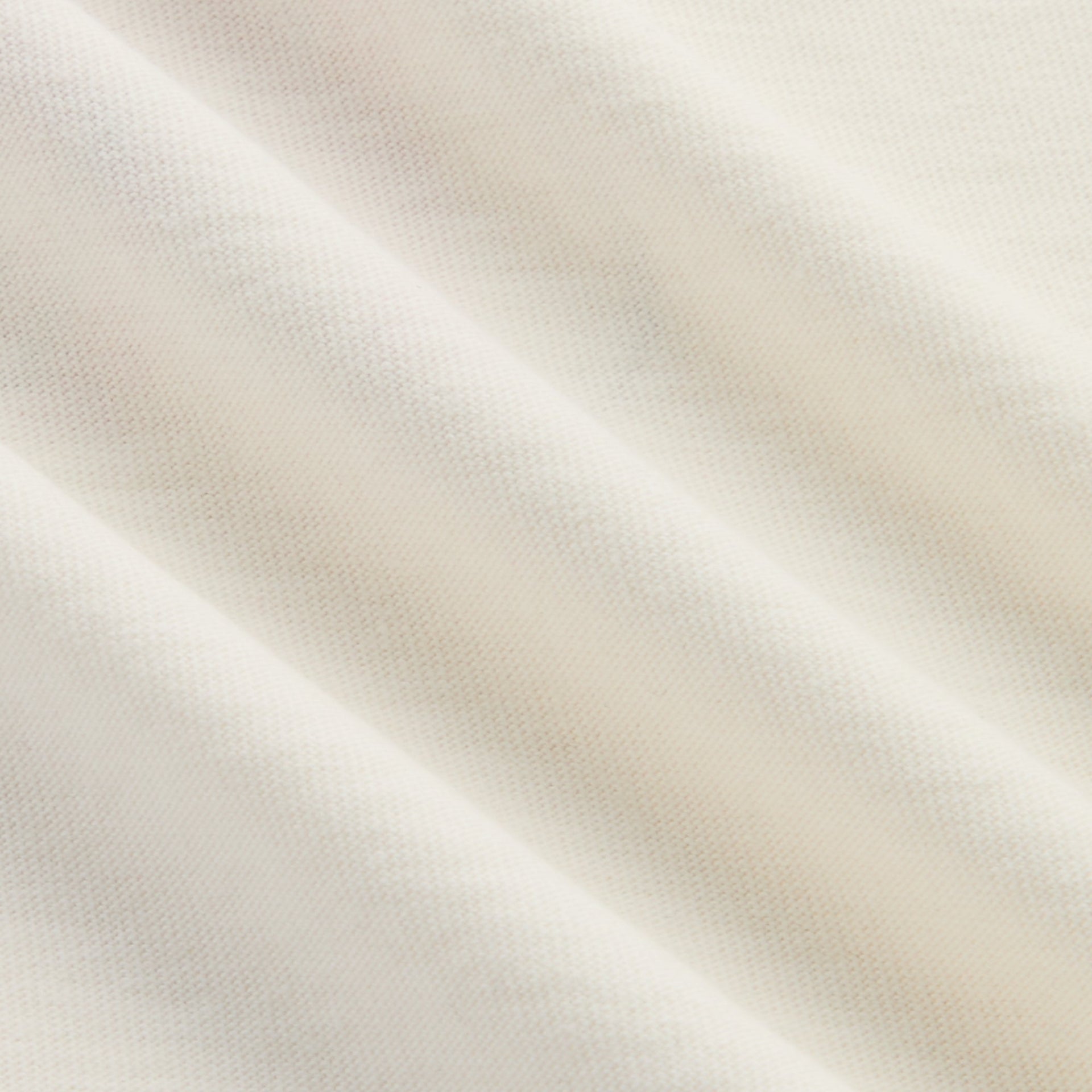 Close-up of the soft cream cotton jersey fabric of the Kith Kids long sleeve Quinn tee