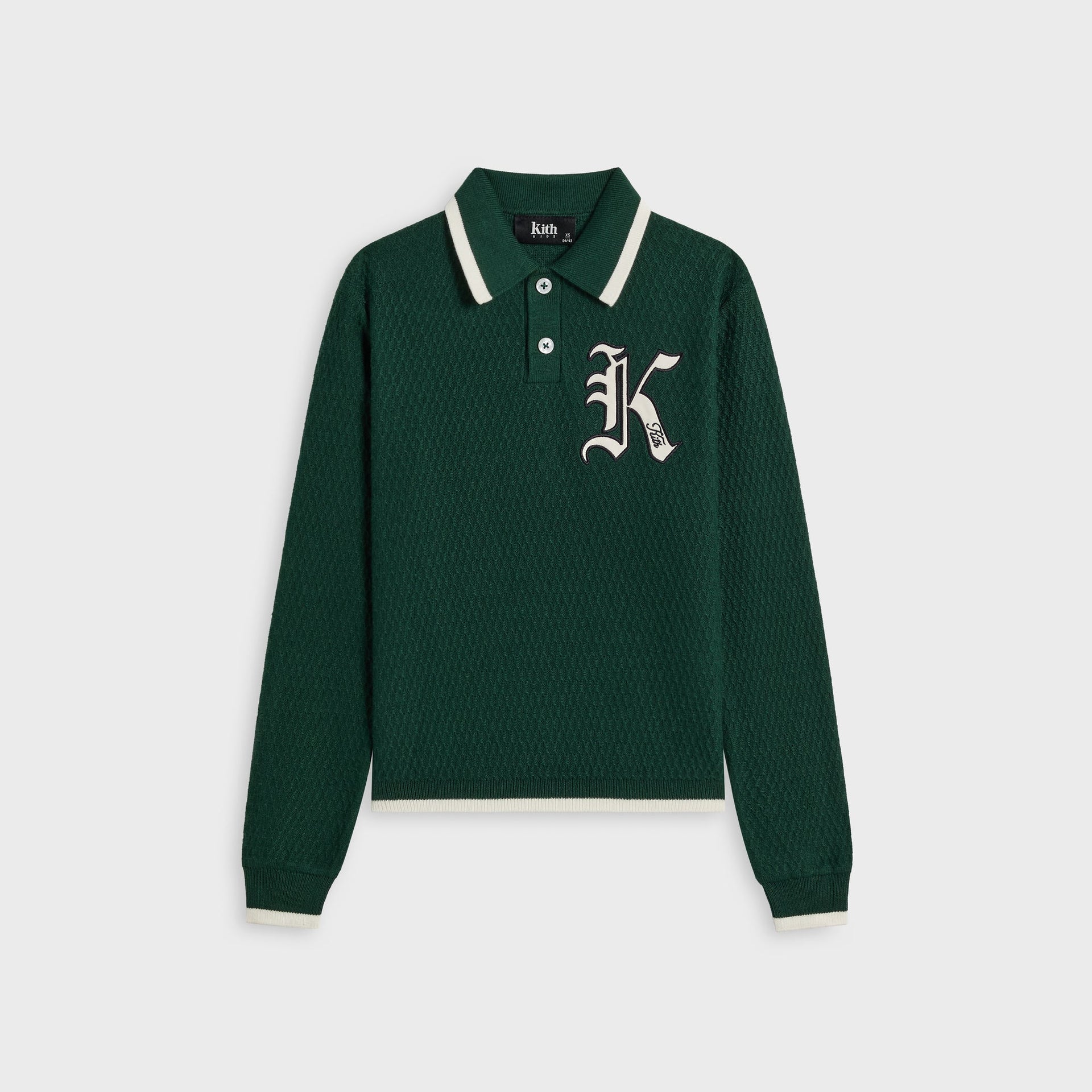 Kith Kids Tilden Long Sleeve Polo in dark green textured knit, front flat lay with cream-tipped collar and old English K Kith chest patch