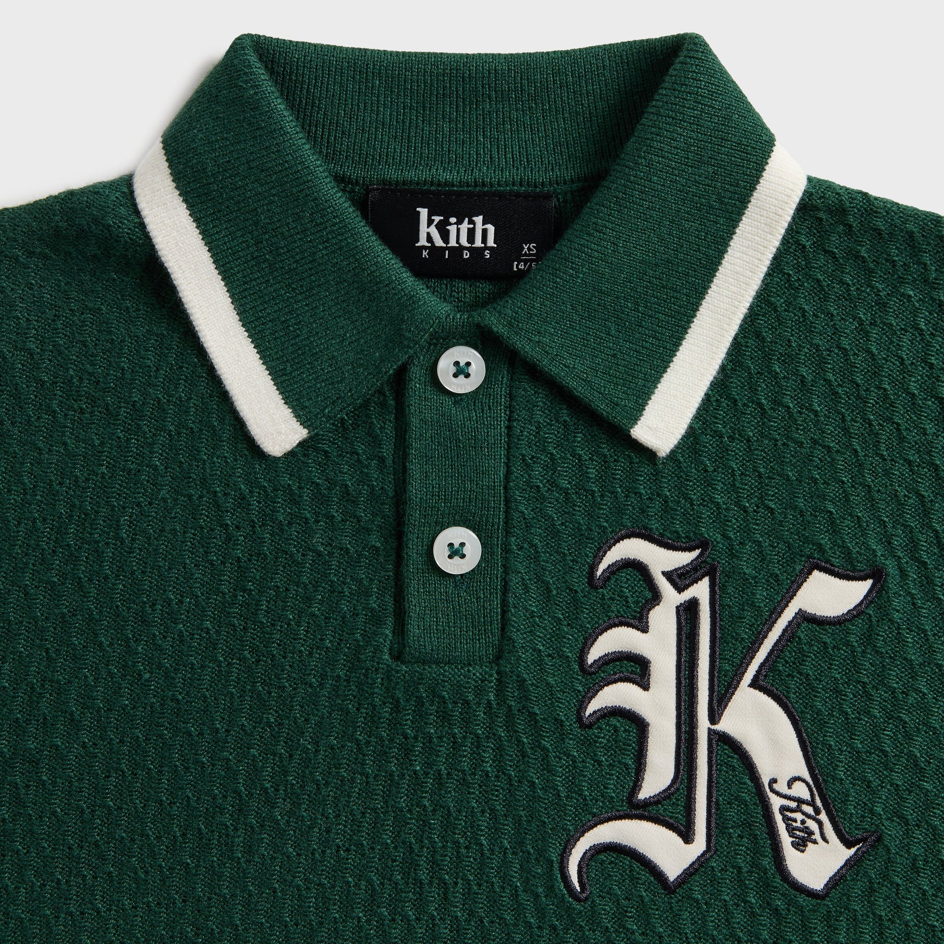 Kith Kids Tilden Long Sleeve Polo, close-up of cream-tipped collar, button placket and old English K Kith patch