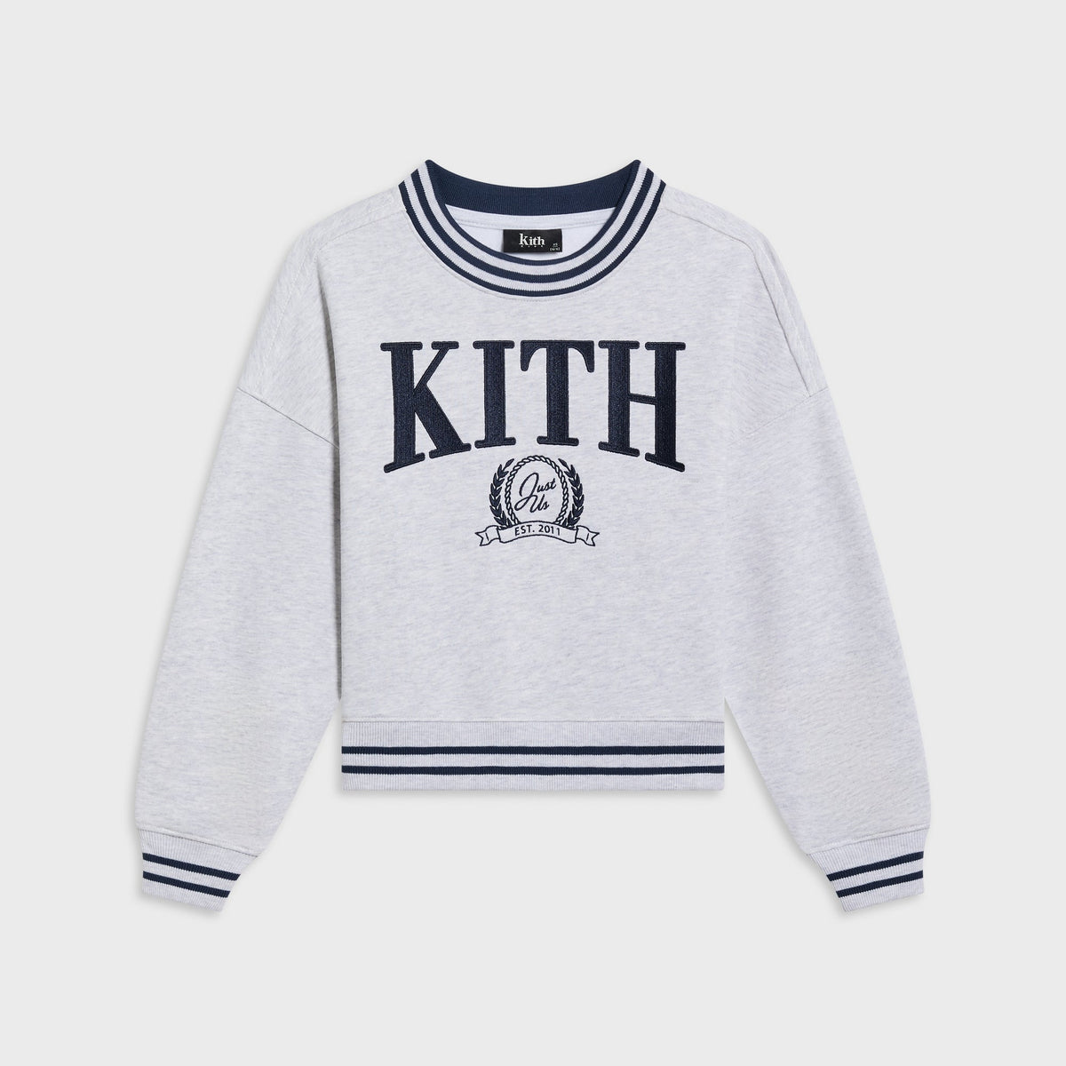 Kith Kids Collegiate Nelson crewneck in light heather grey, flat lay with navy striped ribbing and embroidered KITH crest logo