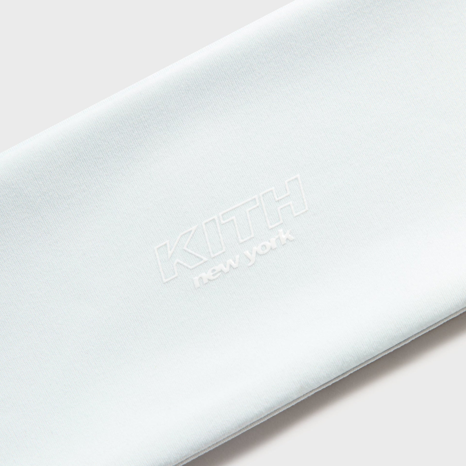 Kith Kids Active Headband in Surry pale mint, close-up of embroidered tonal KITH New York logo