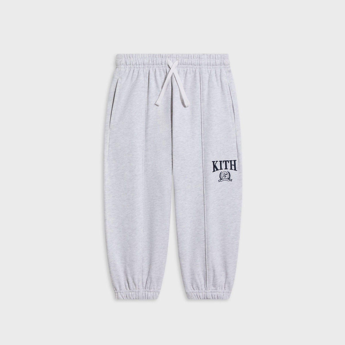 Kith Kids Collegiate Nelson sweatpant in light heather grey, flat lay with drawstring waist and navy KITH crest logo at the leg