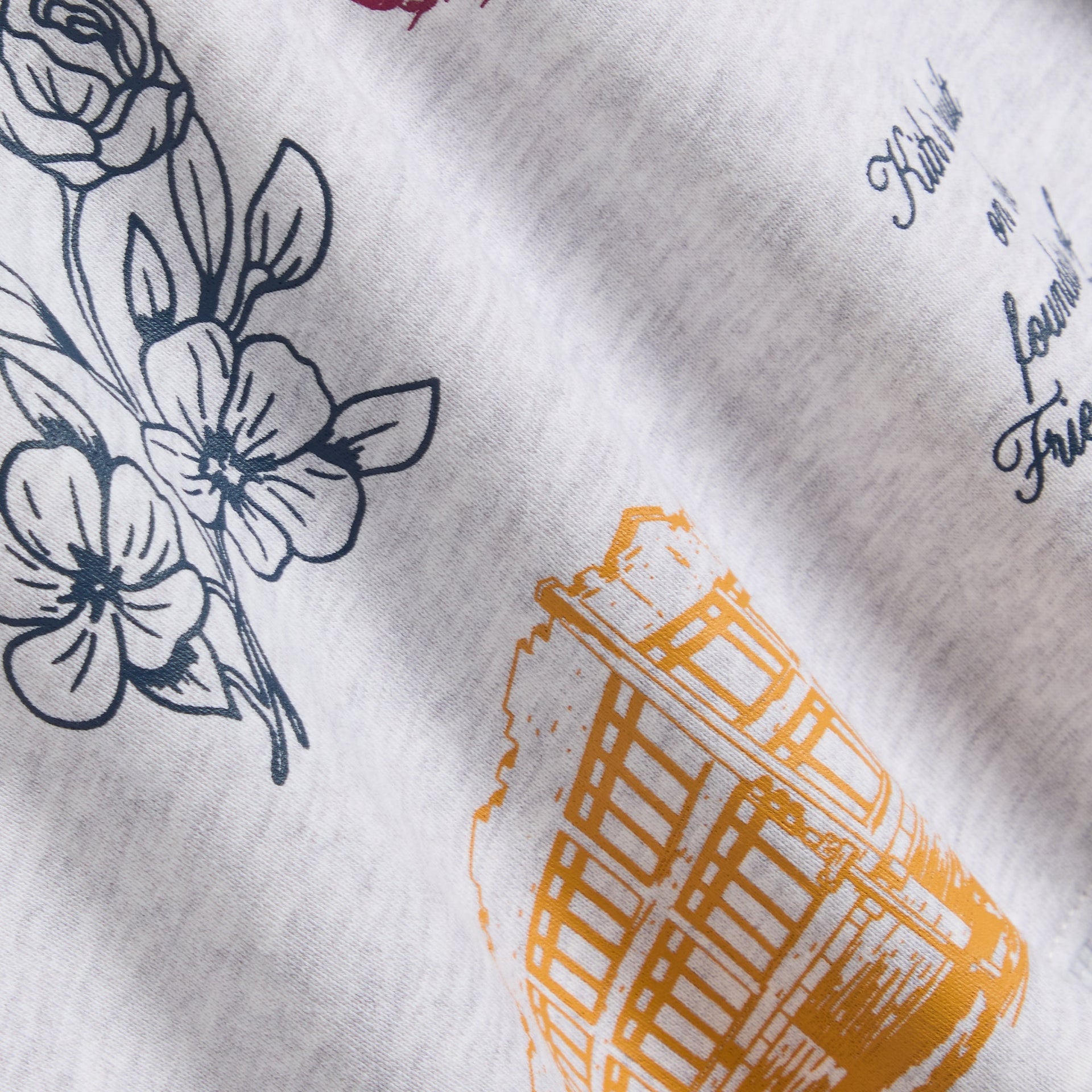 Kith Kids Hoodie Dress fabric close-up of floral and trolley sketch prints on heather grey