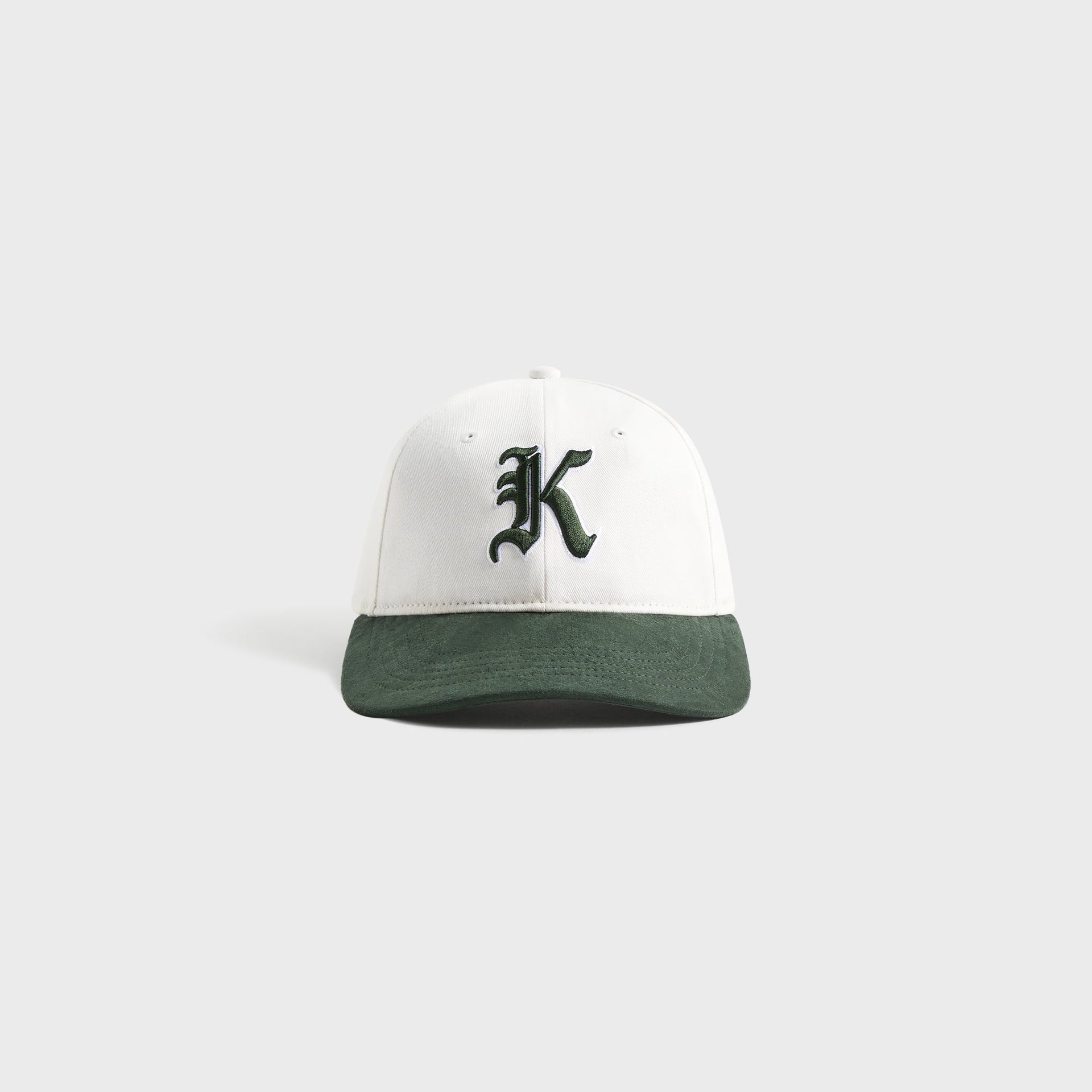 Kith Kids Micro Suede Brim Classic Cap, front view of white crown with green suede brim and Old English K