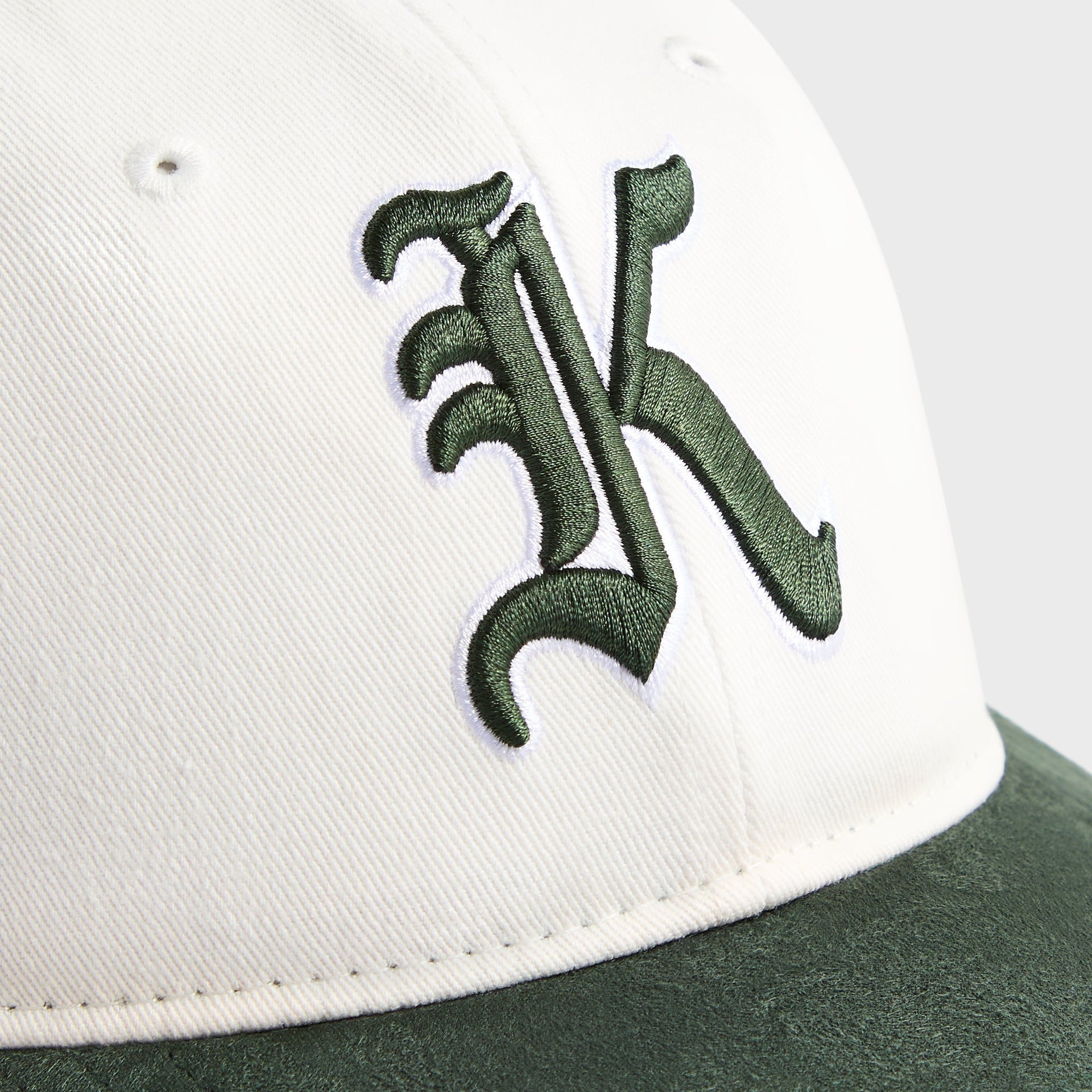 Kith Kids Micro Suede Brim Classic Cap, close-up of green Old English K embroidery on white crown