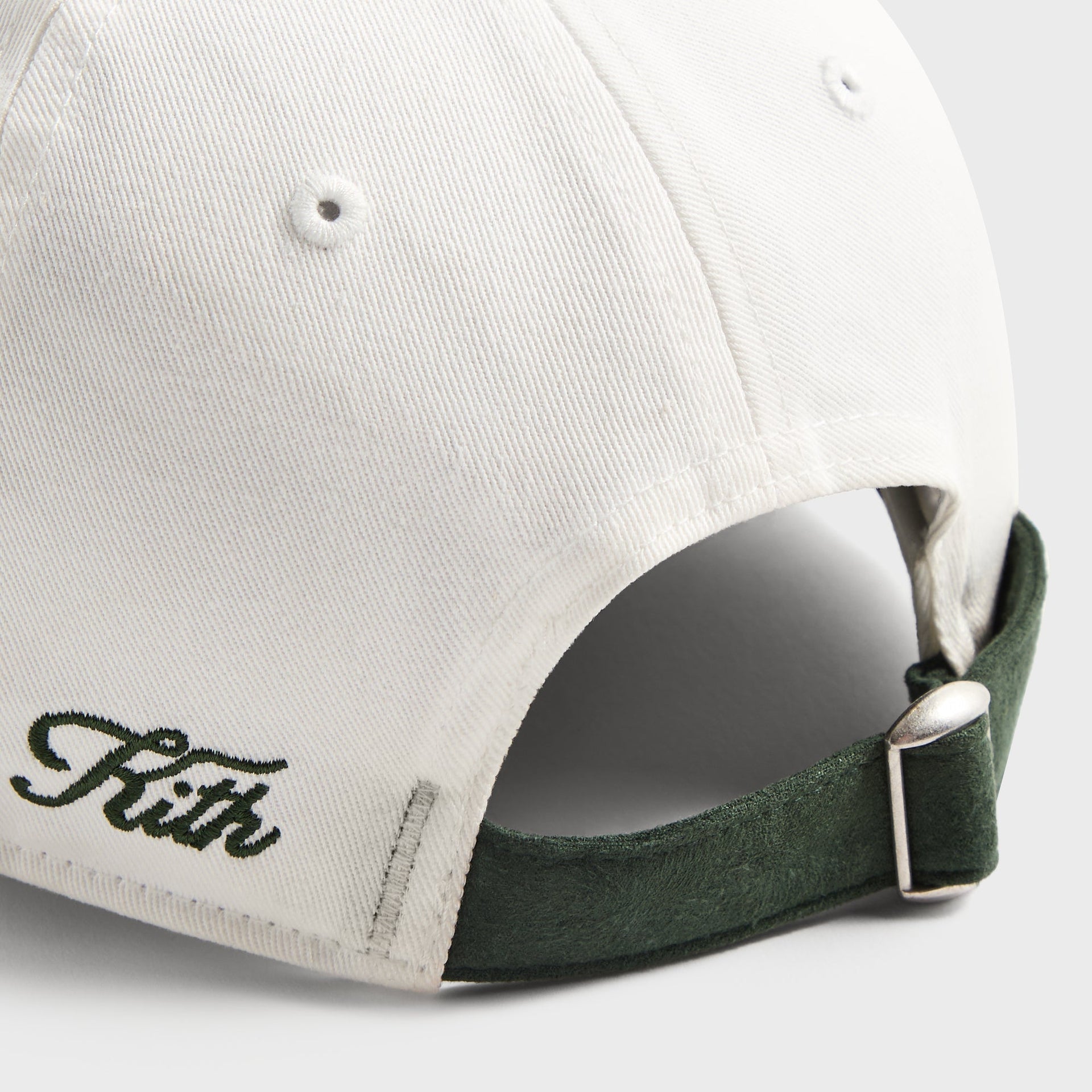 Kith Kids Micro Suede Brim Classic Cap, close-up of back strap with green Kith script and metal buckle