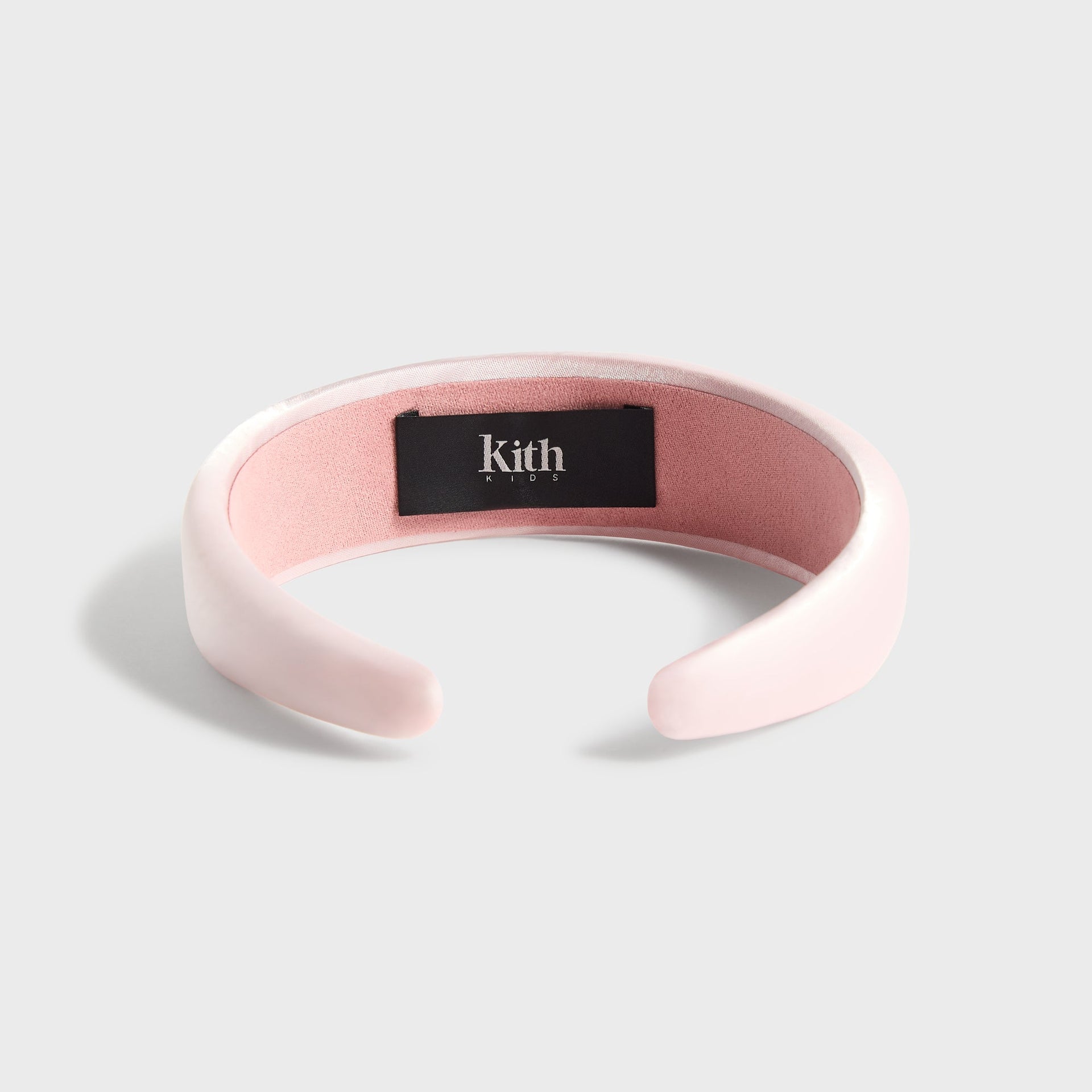 Kith Kids Satin Headband in Bloom pink, interior view with pink lining and black Kith Kids tag