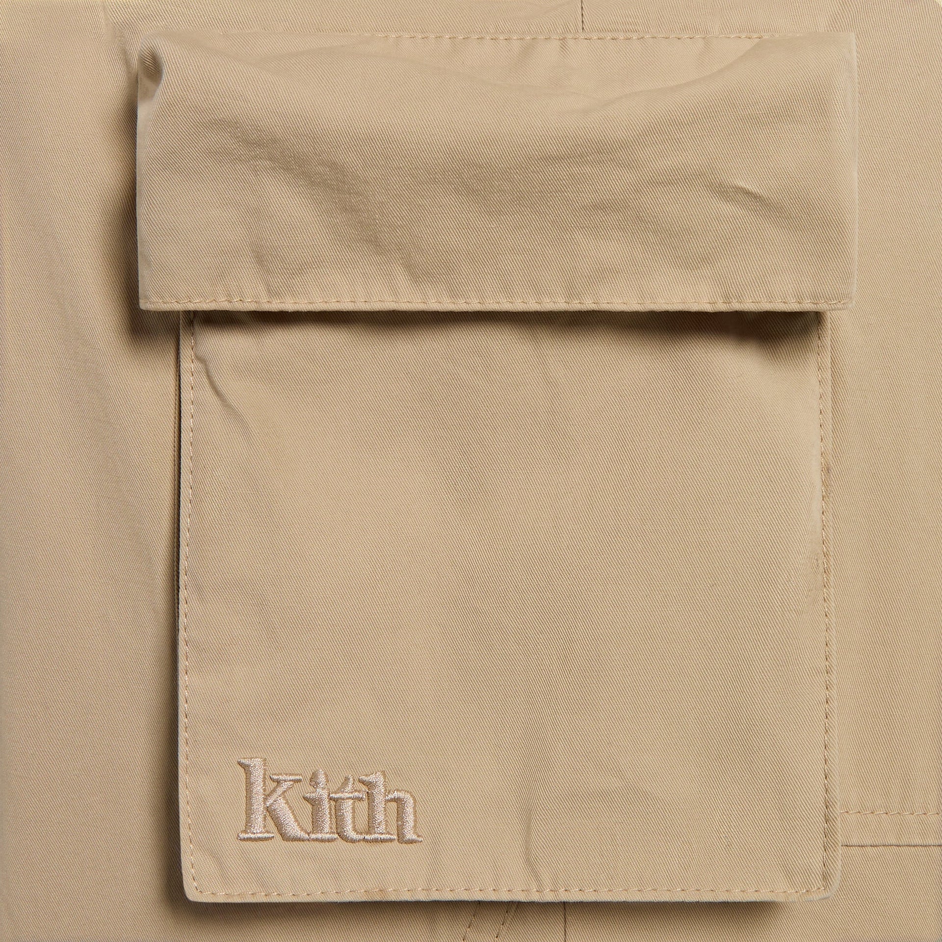 Kith Kids Chauncey Cargo Pant close-up of tan flap cargo pocket with embroidered Kith logo