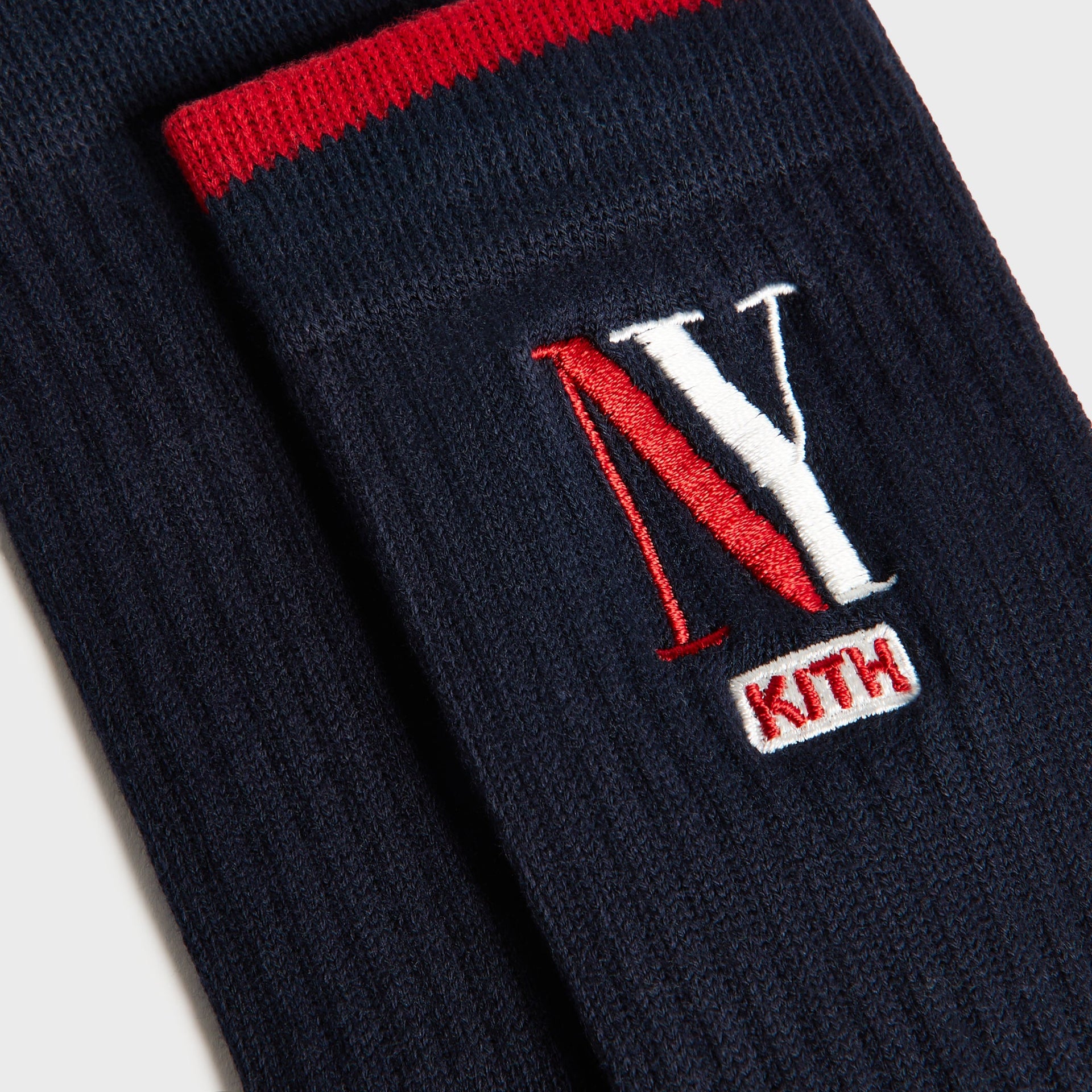 Kith Kids NY Socks, close-up of navy sock with red stripe and NY Kith embroidery