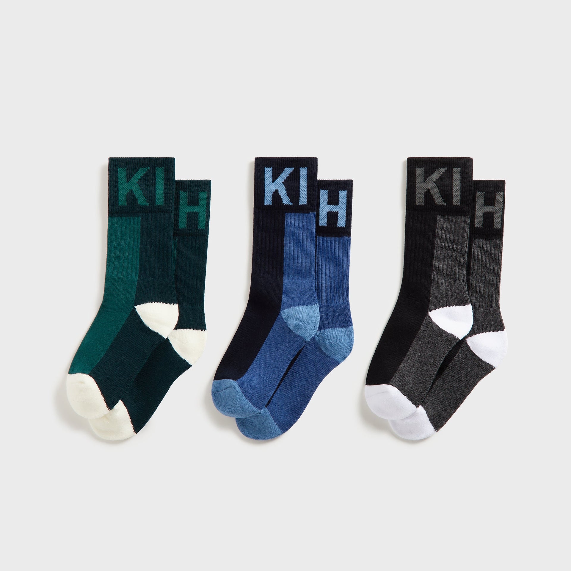 Kith Kids 3-Pack Color-Blocked Socks flat lay of green, blue and black crew socks with KITH cuff lettering