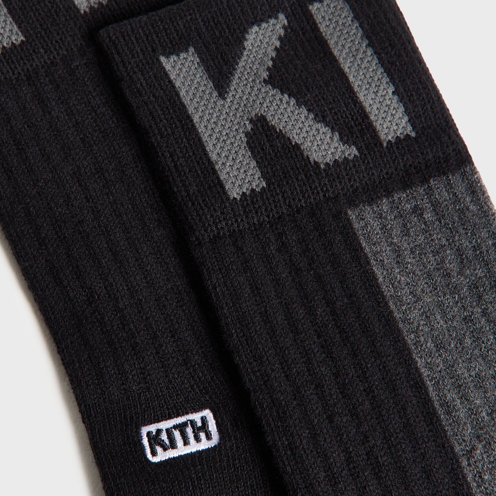 Kith Kids 3-Pack Color-Blocked Socks close-up of black and charcoal pair with grey KITH lettering