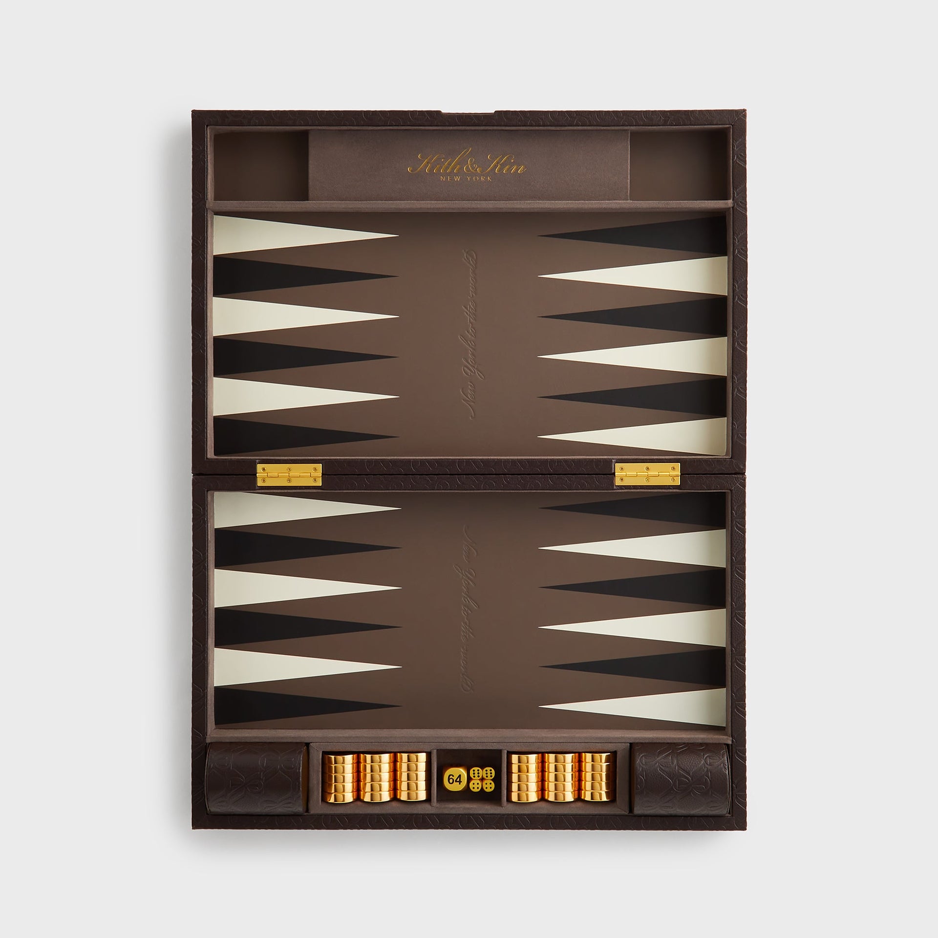Top-down view of the fully opened Kith Crest Monogram Backgammon Board with gold checkers and doubling dice