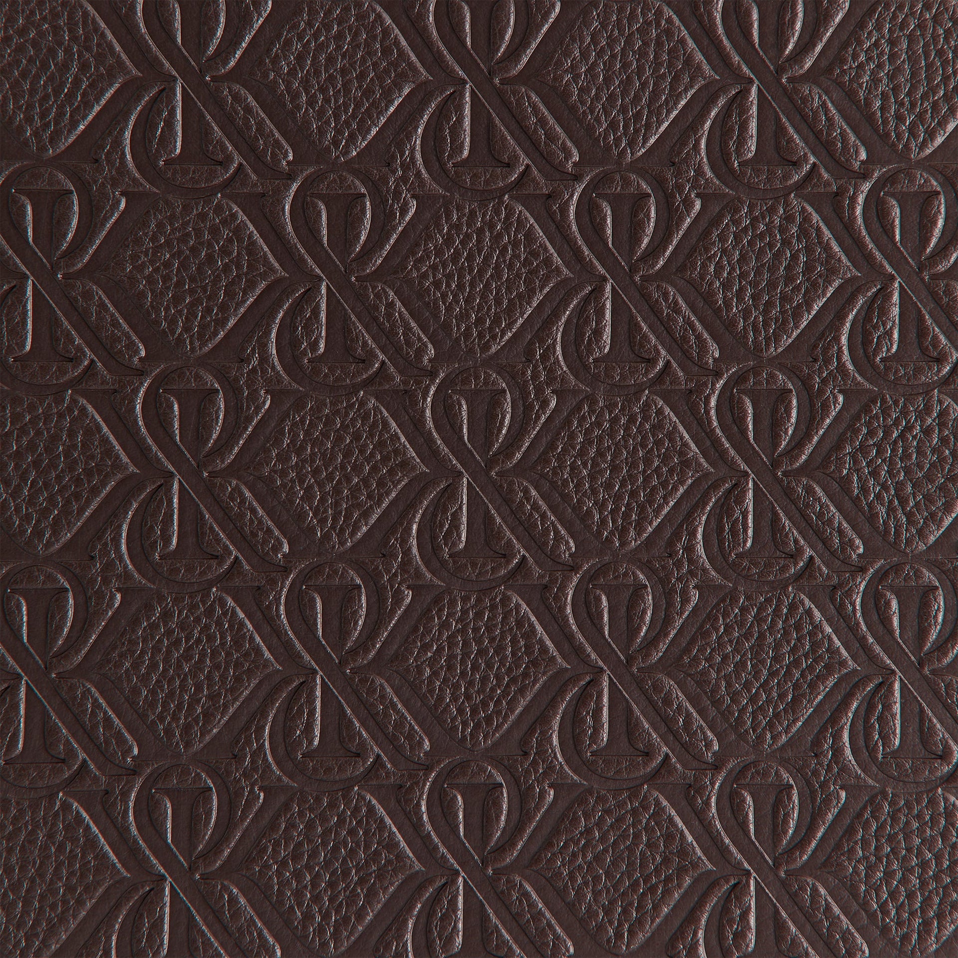 Macro texture detail of the embossed Kith monogram pattern covering the backgammon case exterior