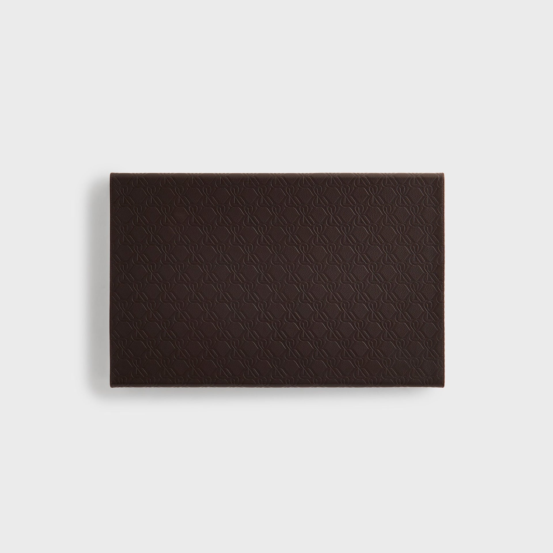 Top-down view of the closed Kith Crest Monogram Backgammon Board case in Incognito dark brown leather