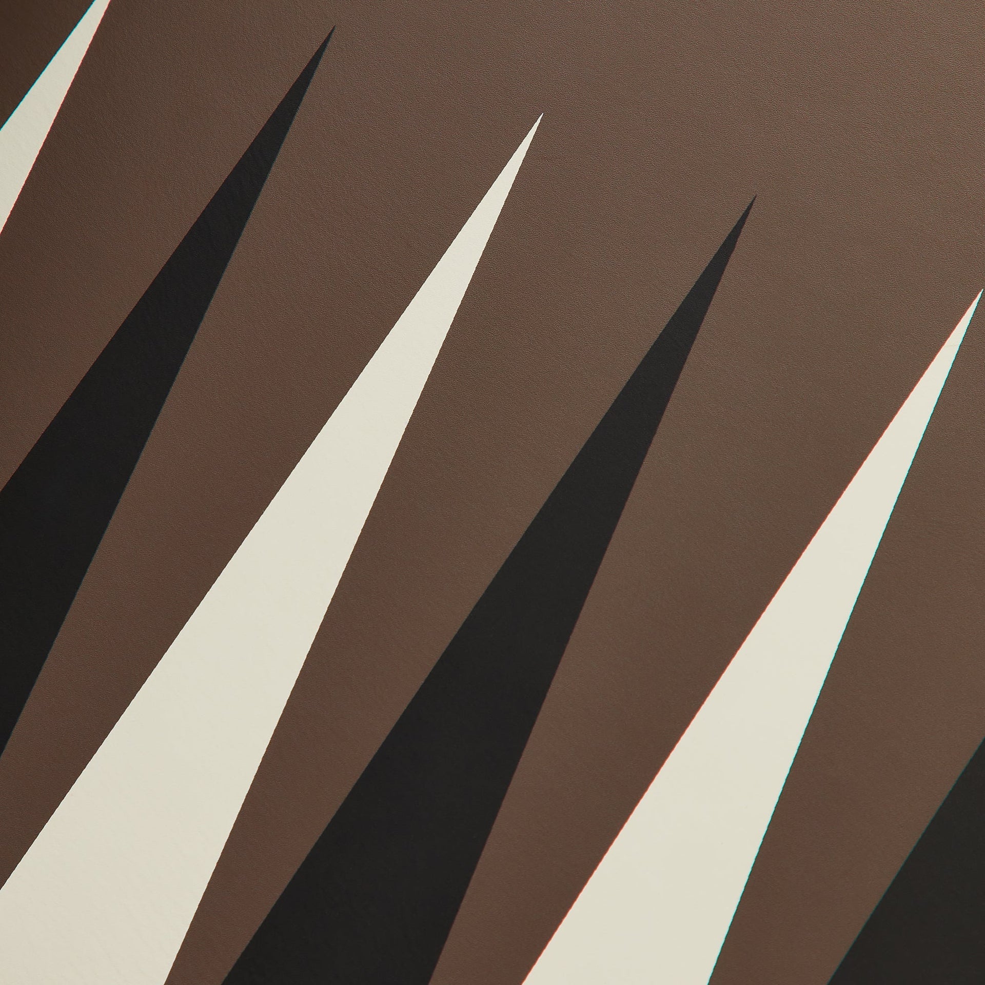 Detail shot of the diagonal black and cream leather playing triangles on the backgammon board surface
