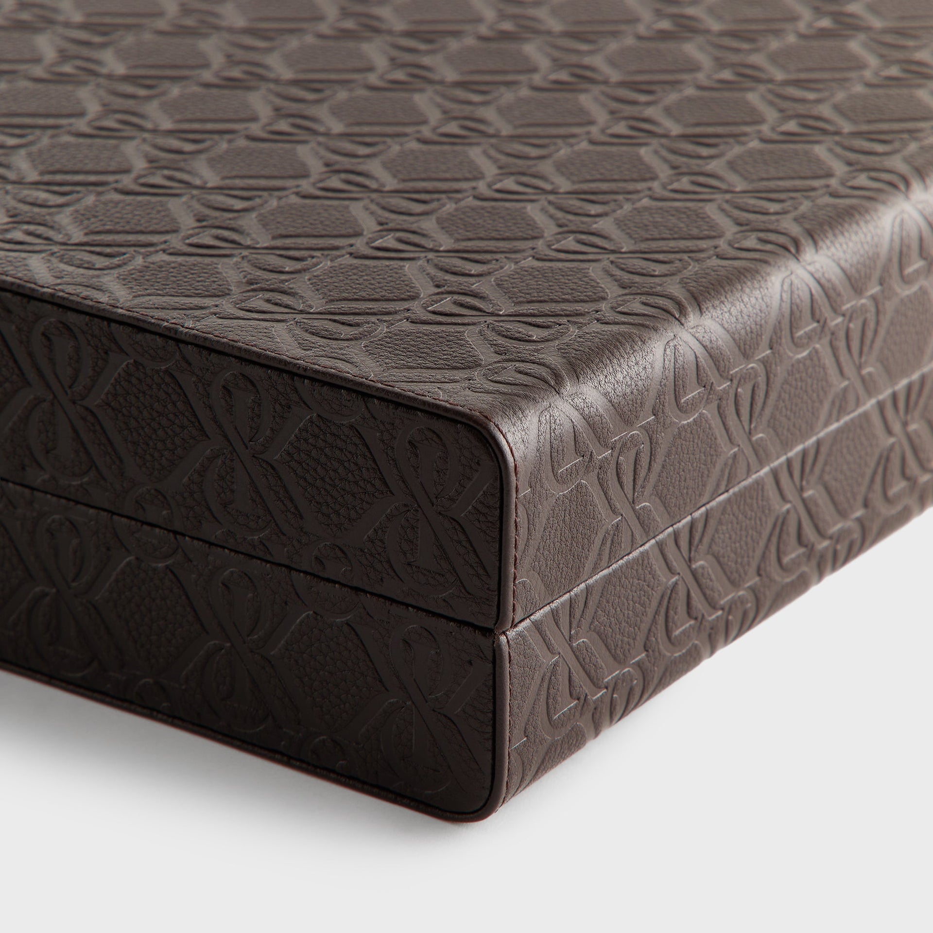 Close-up of the stitched corner edge and embossed leather exterior of the closed backgammon case