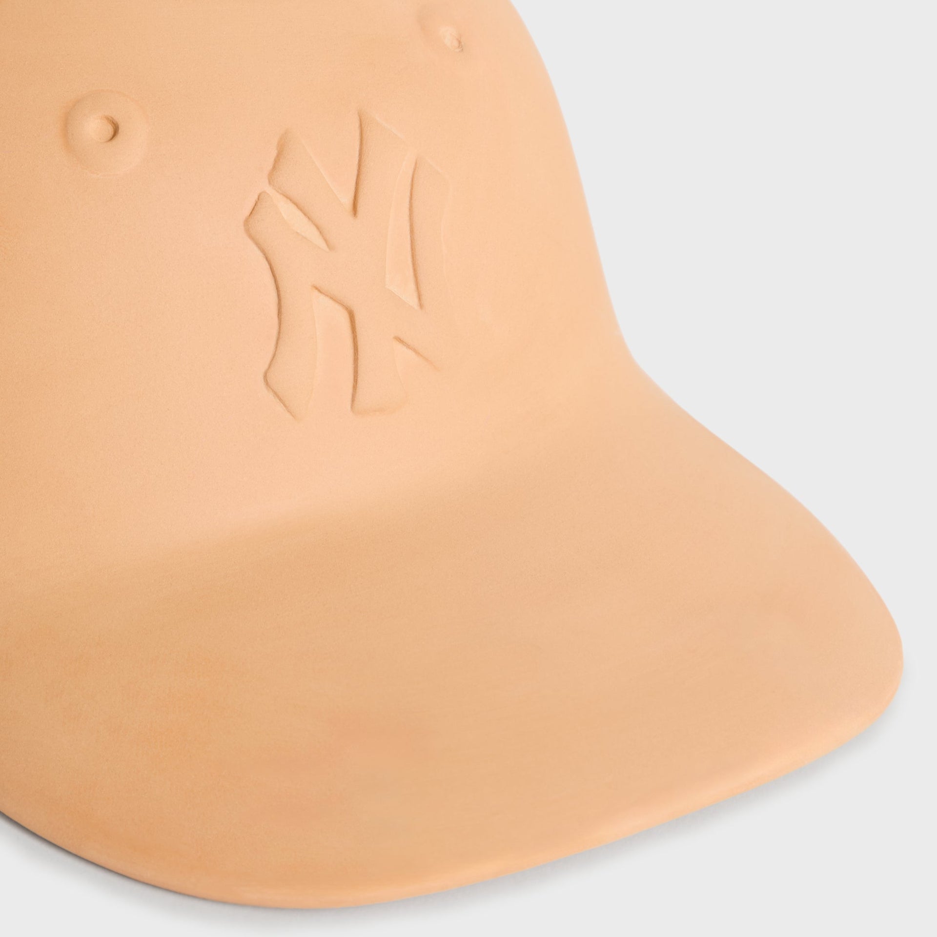 Close-up detail of the embossed New York Yankees logo on the terracotta cap planter