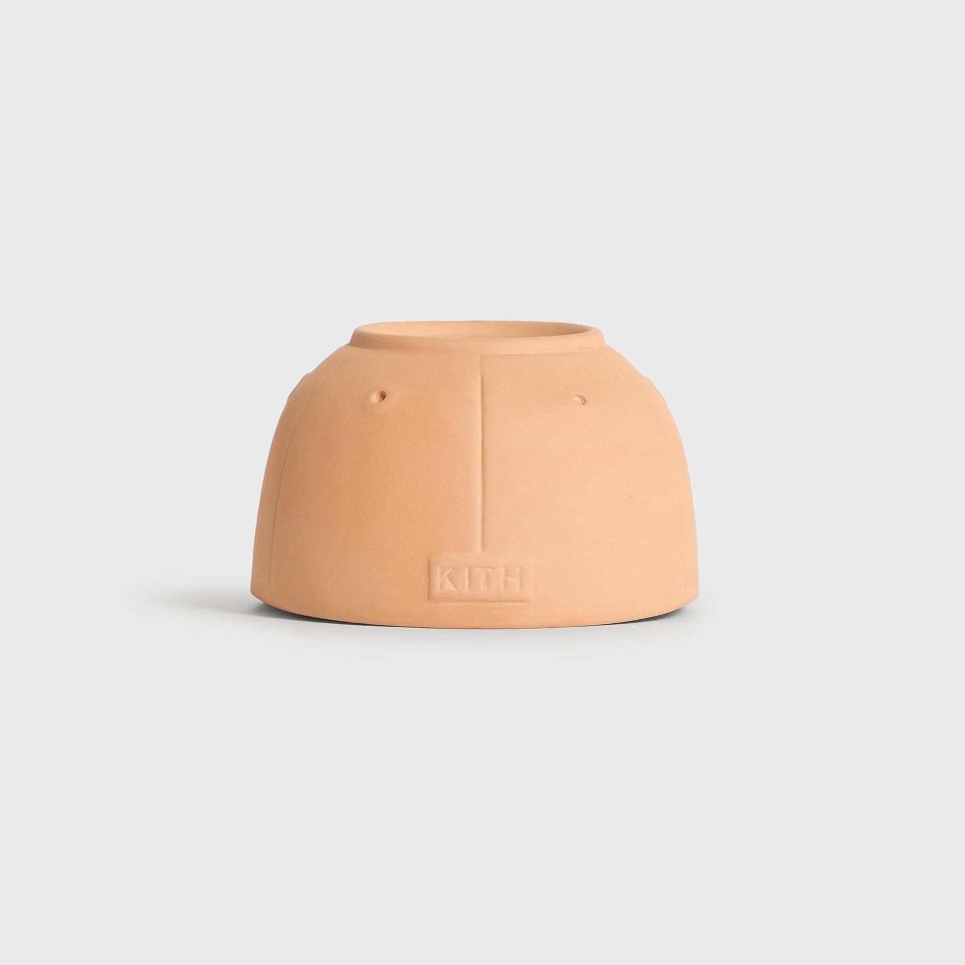 Back view of the Kith x New York Yankees terracotta cap planter showing the embossed Kith wordmark
