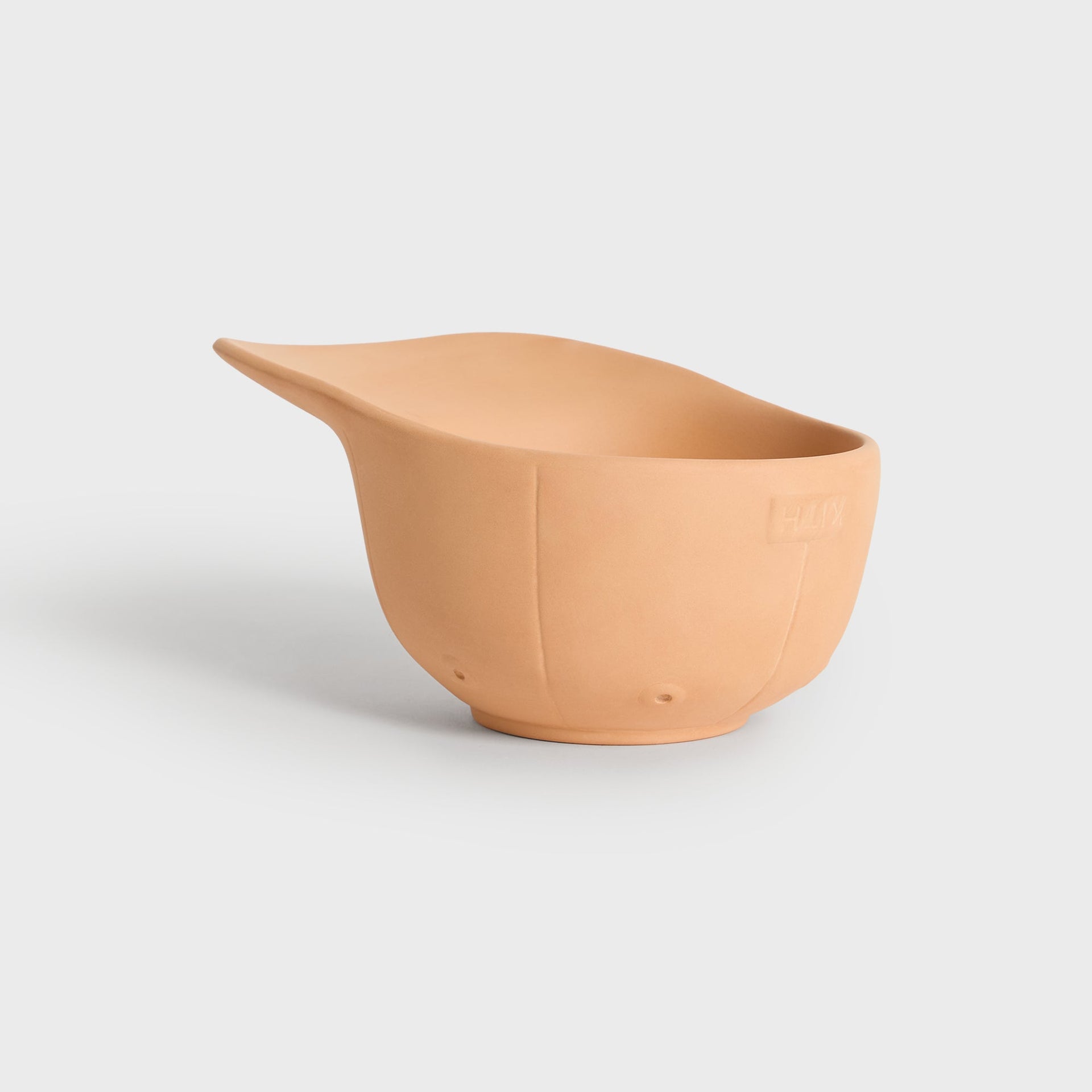 Wide side angle of the terracotta cap planter showing the scooped brim shape and Kith logo