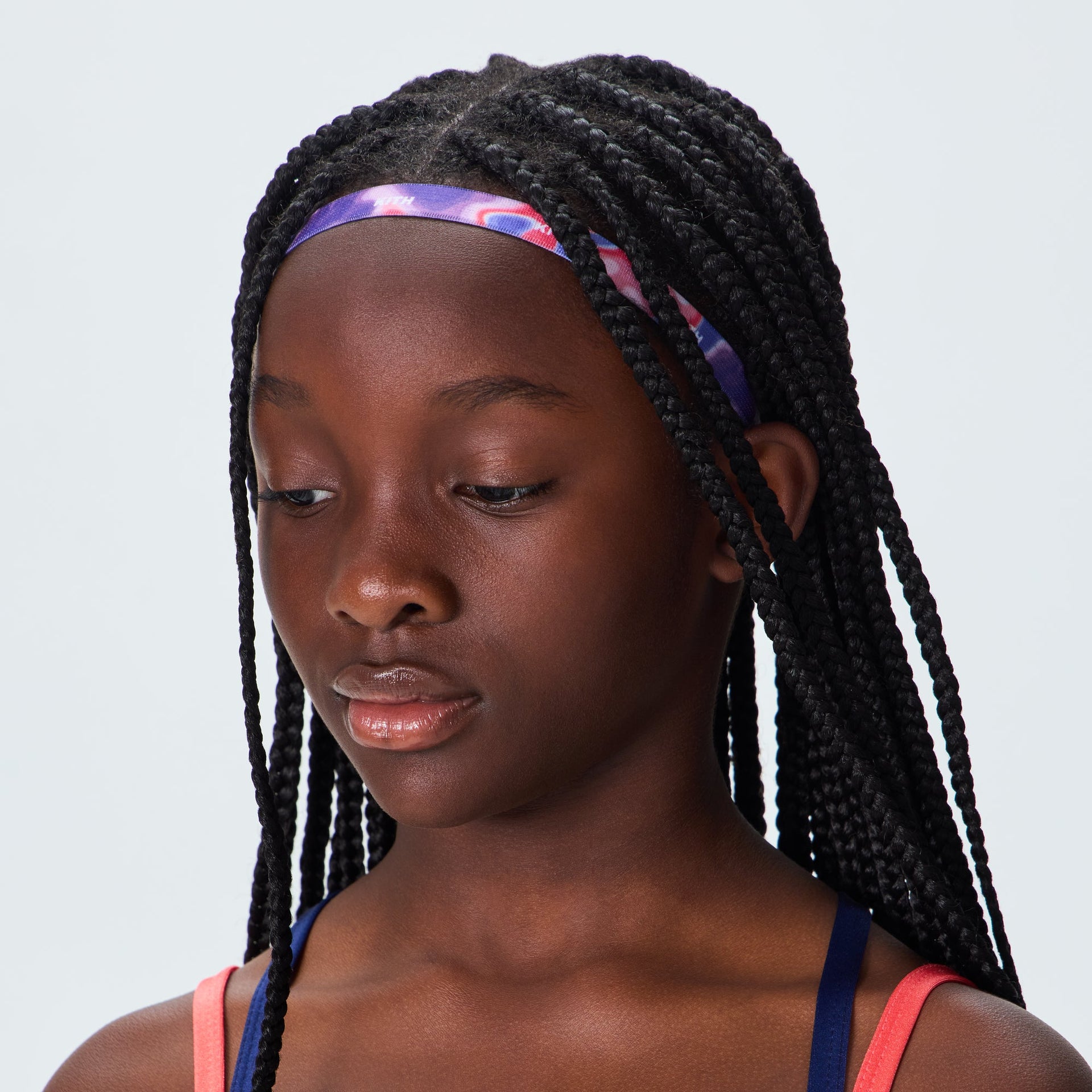 Kith Kids Printed Headband in pink and purple swirl print, worn by child, front view