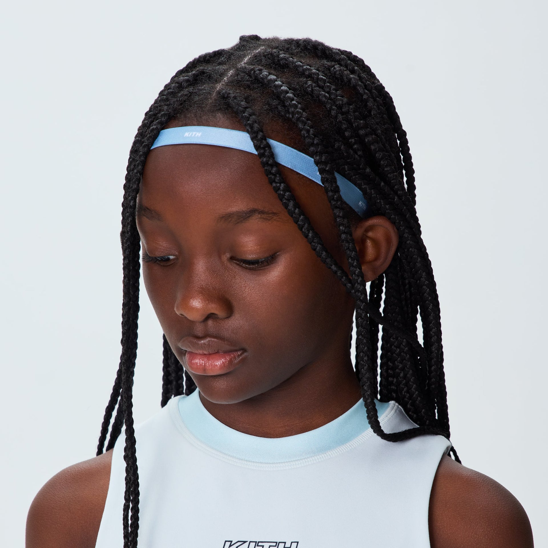 Kith Kids Printed Headband in light blue with white logo, worn by child, side view