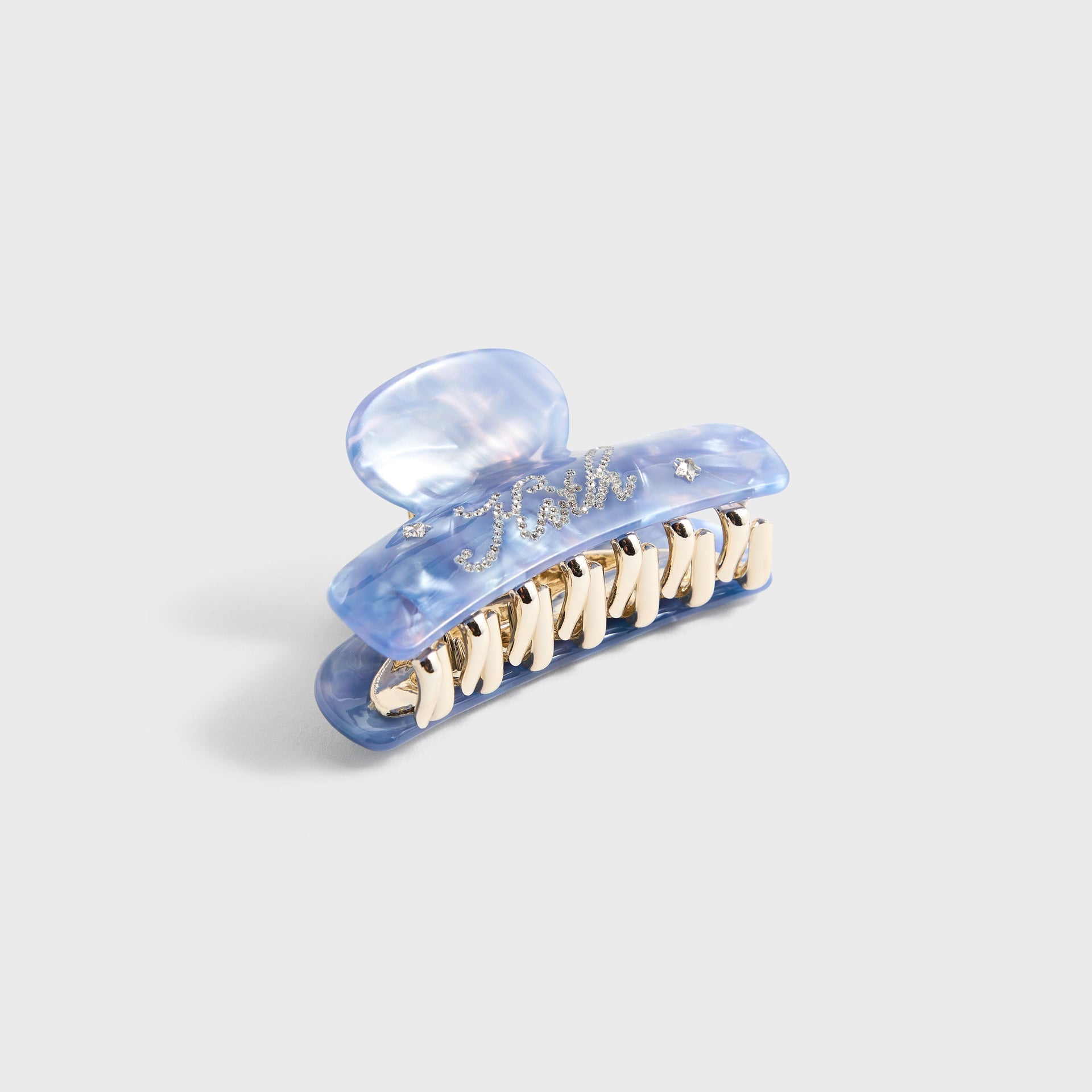 Kith Kids Rhinestone Hair Clip in blue marble with rhinestone Kith script, angled view