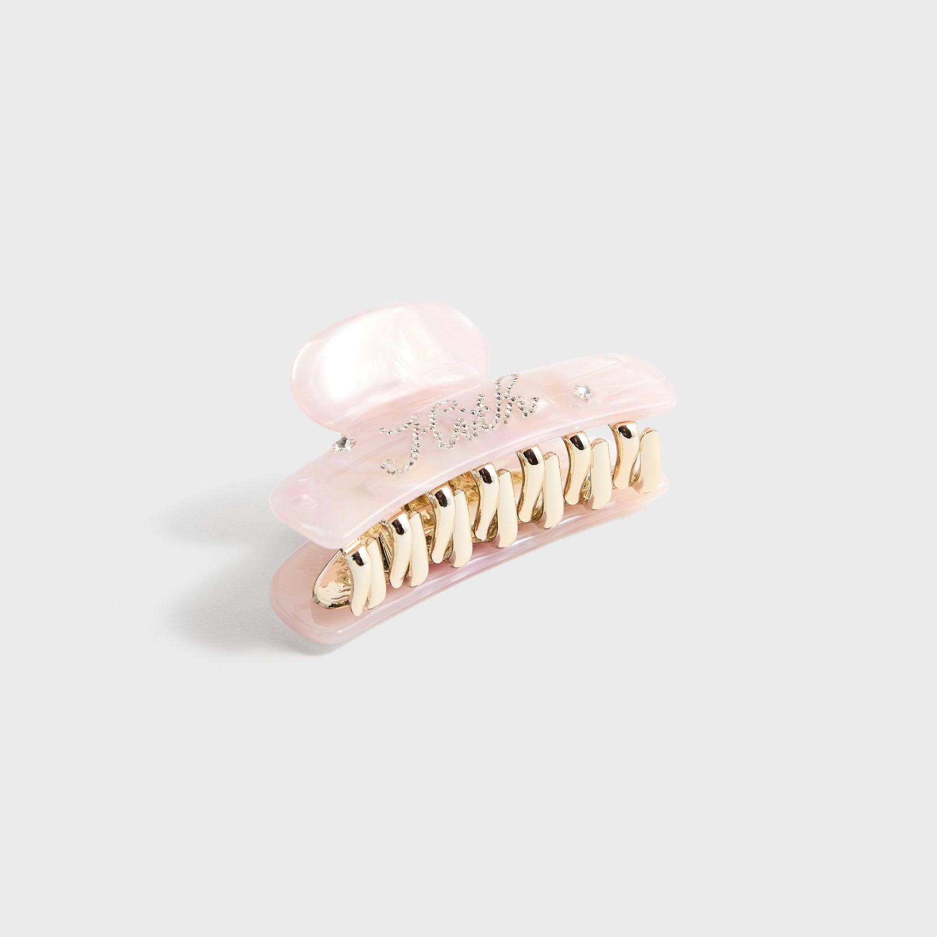 Kith Kids Rhinestone Hair Clip in pink marble with rhinestone Kith script, angled view