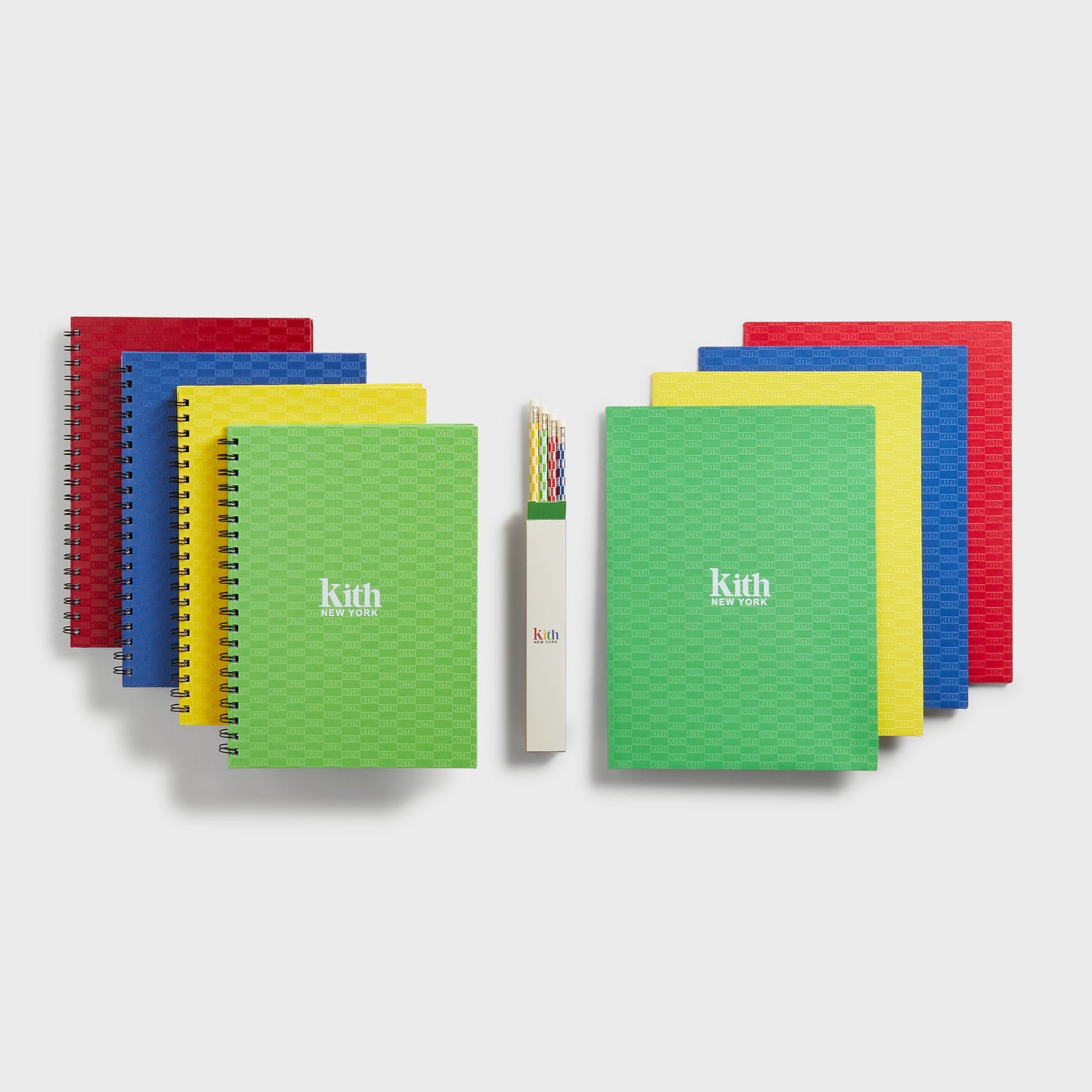 Kith Kids Back to School Supplies Box Set, full flat lay of red, blue, yellow and green Kith notebooks and pencils