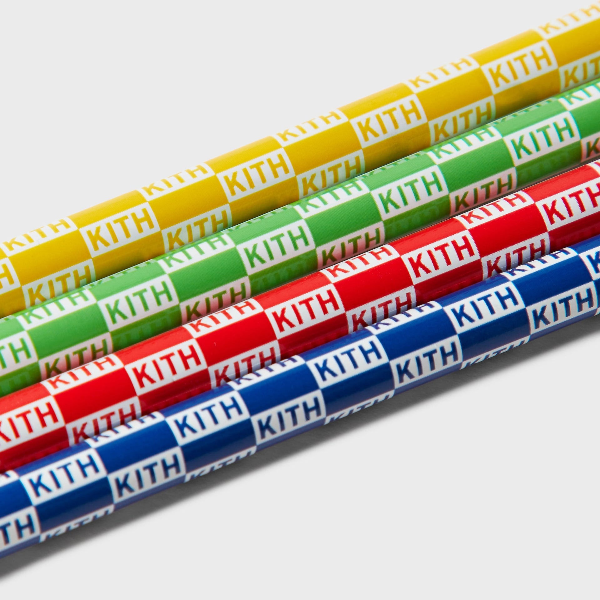 Kith Kids Back to School Set, angled close-up of four Kith checkerboard logo pencils