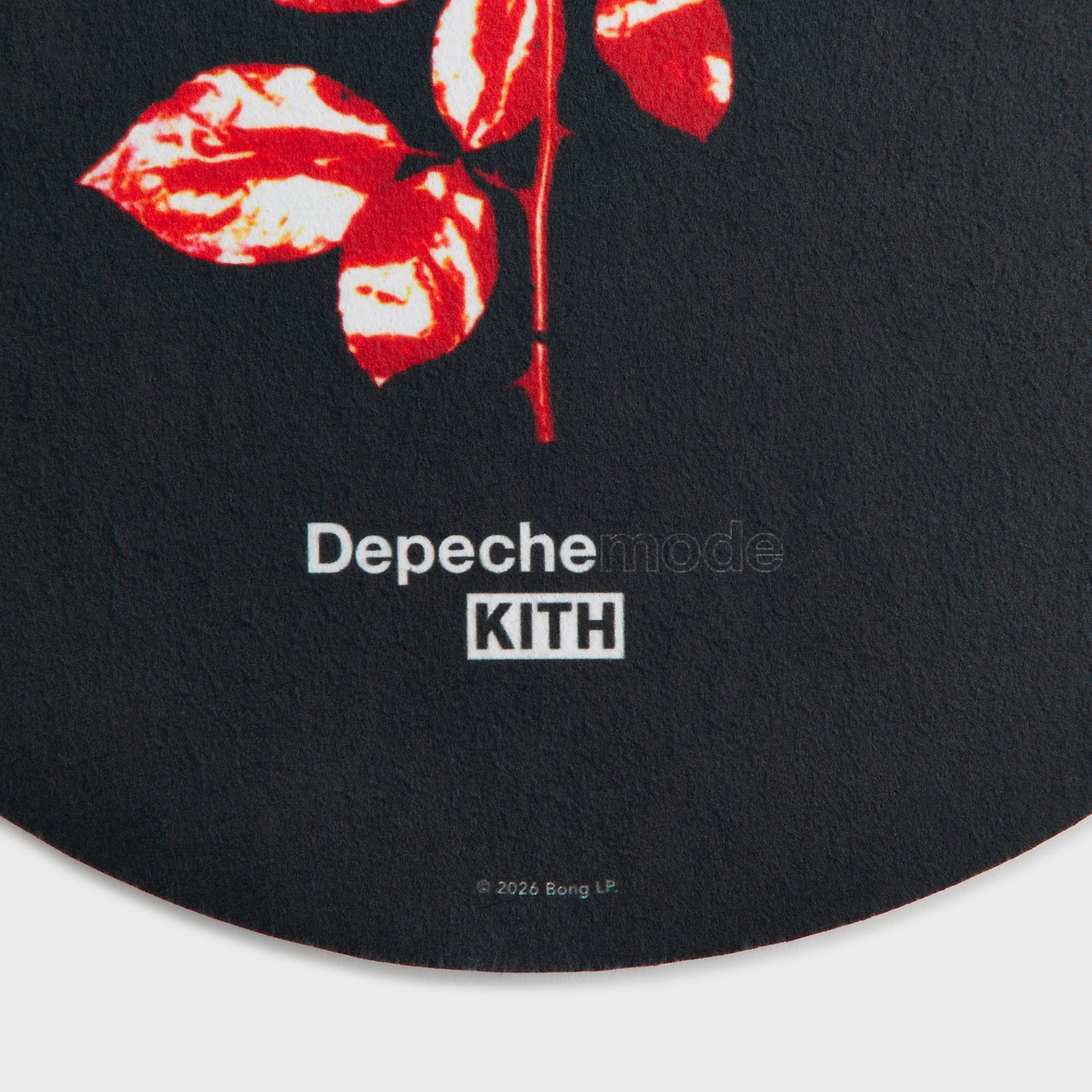 Close-up of the rose leaves and Depeche Mode Kith logo on the black slip mat
