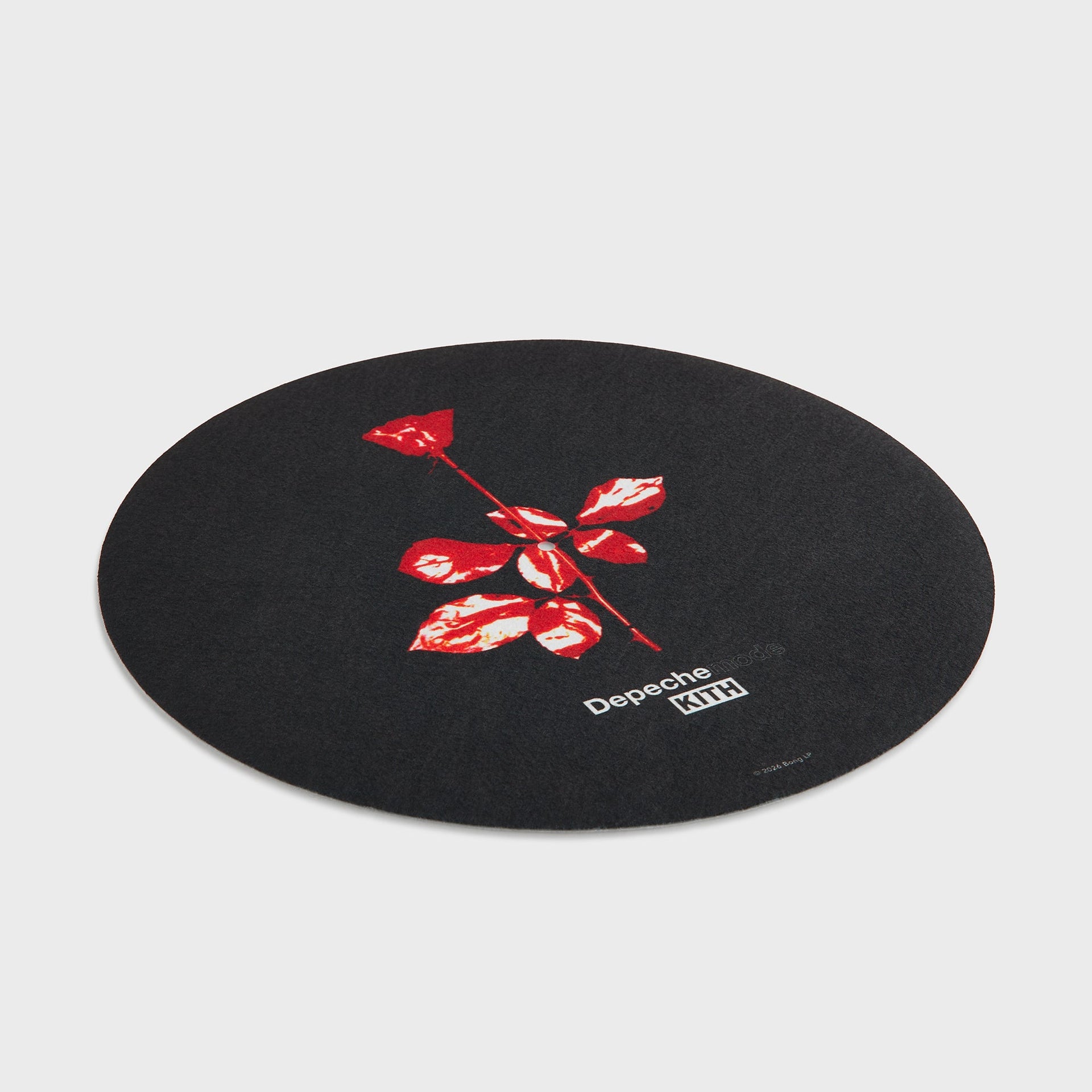 Angled view of the Depeche Mode red rose slip mat from the Kith Records set lying flat