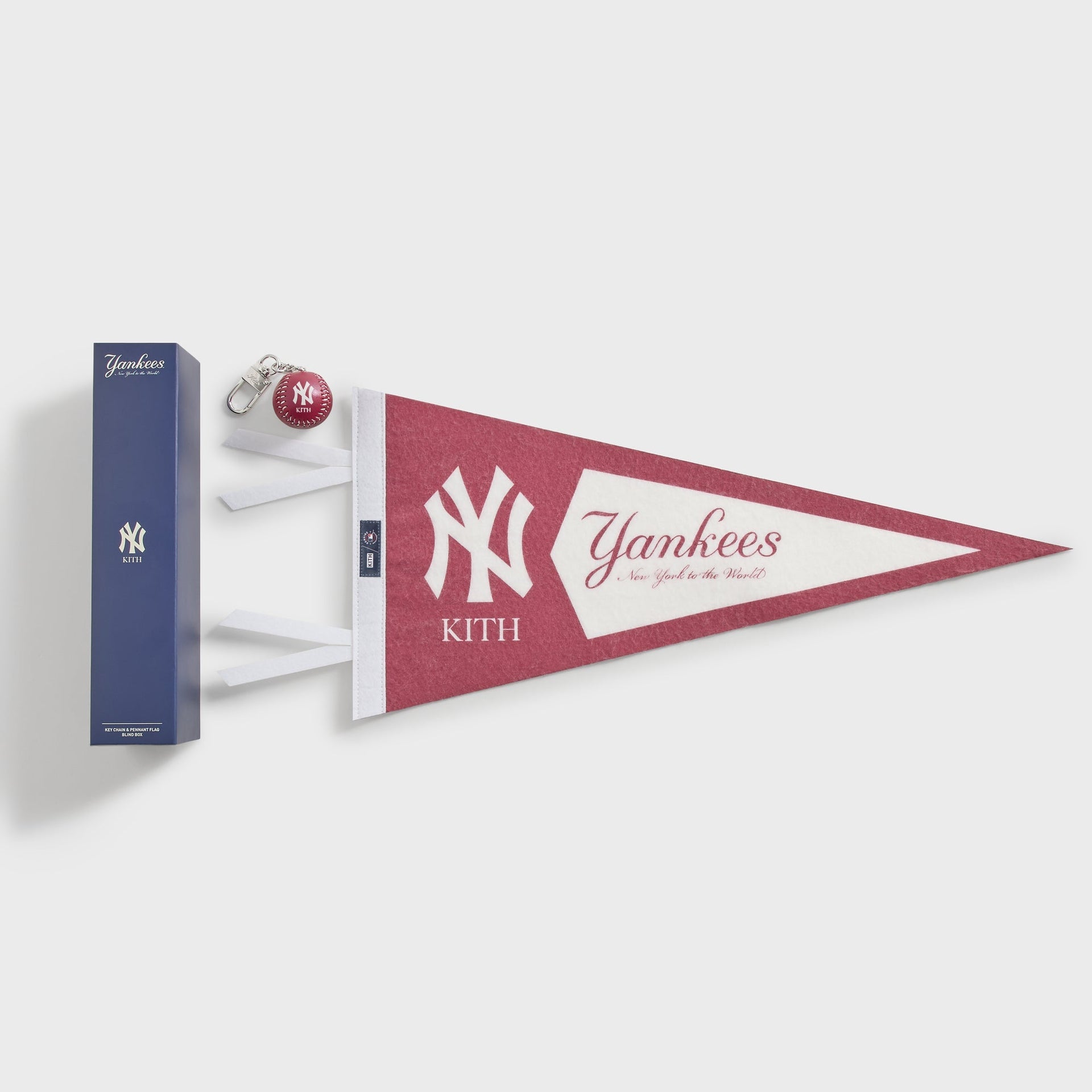 Kith x New York Yankees blind box contents: a leather baseball keychain and felt pennant flag