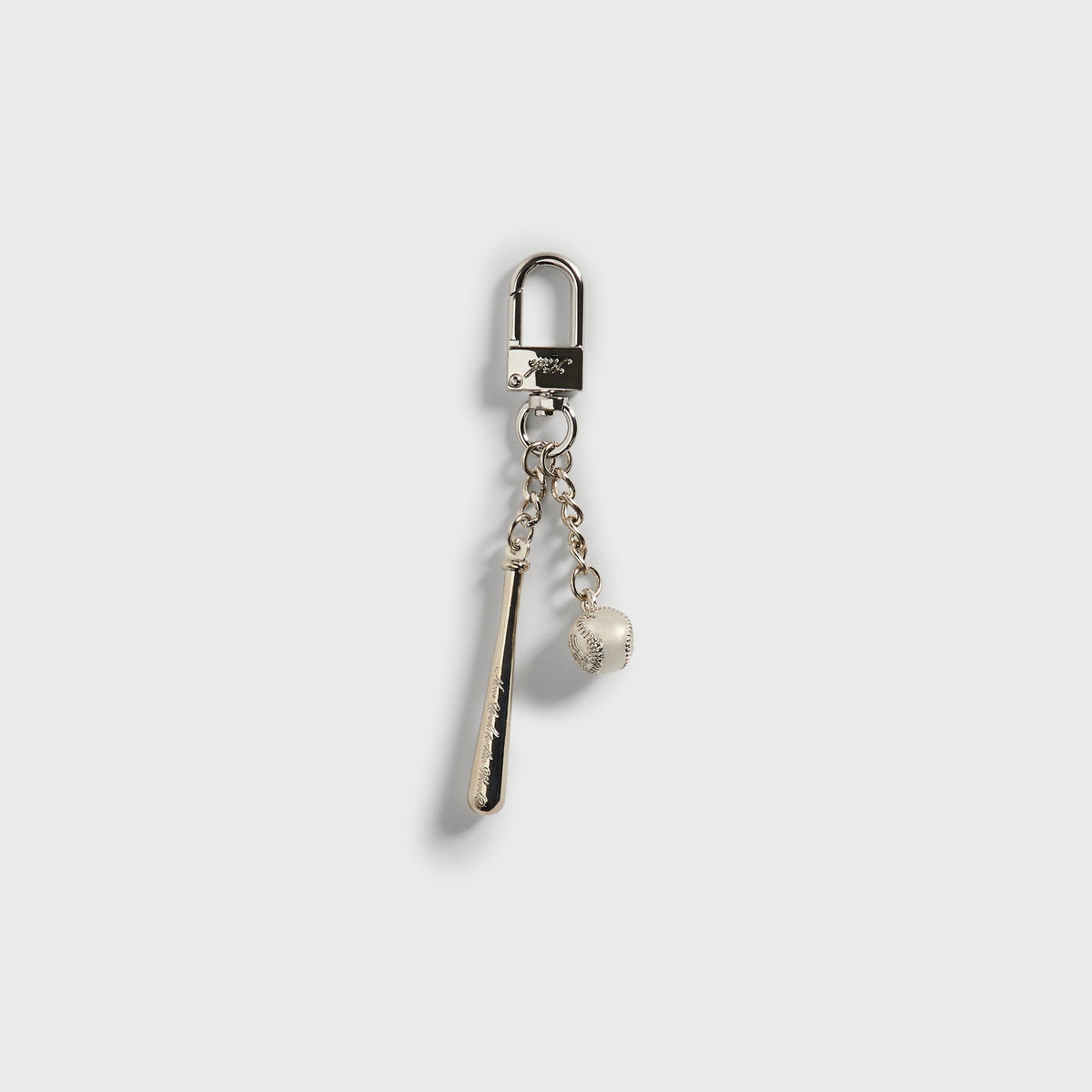 Kith x Yankees Baseball & Bat Keychain - angled view of silver bat and baseball charms on lobster clasp