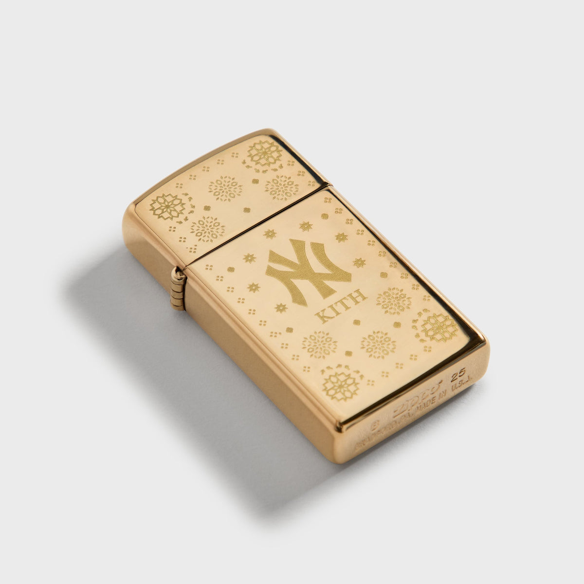 Kith x New York Yankees gold Zippo lighter closed, angled top-down view of engraving