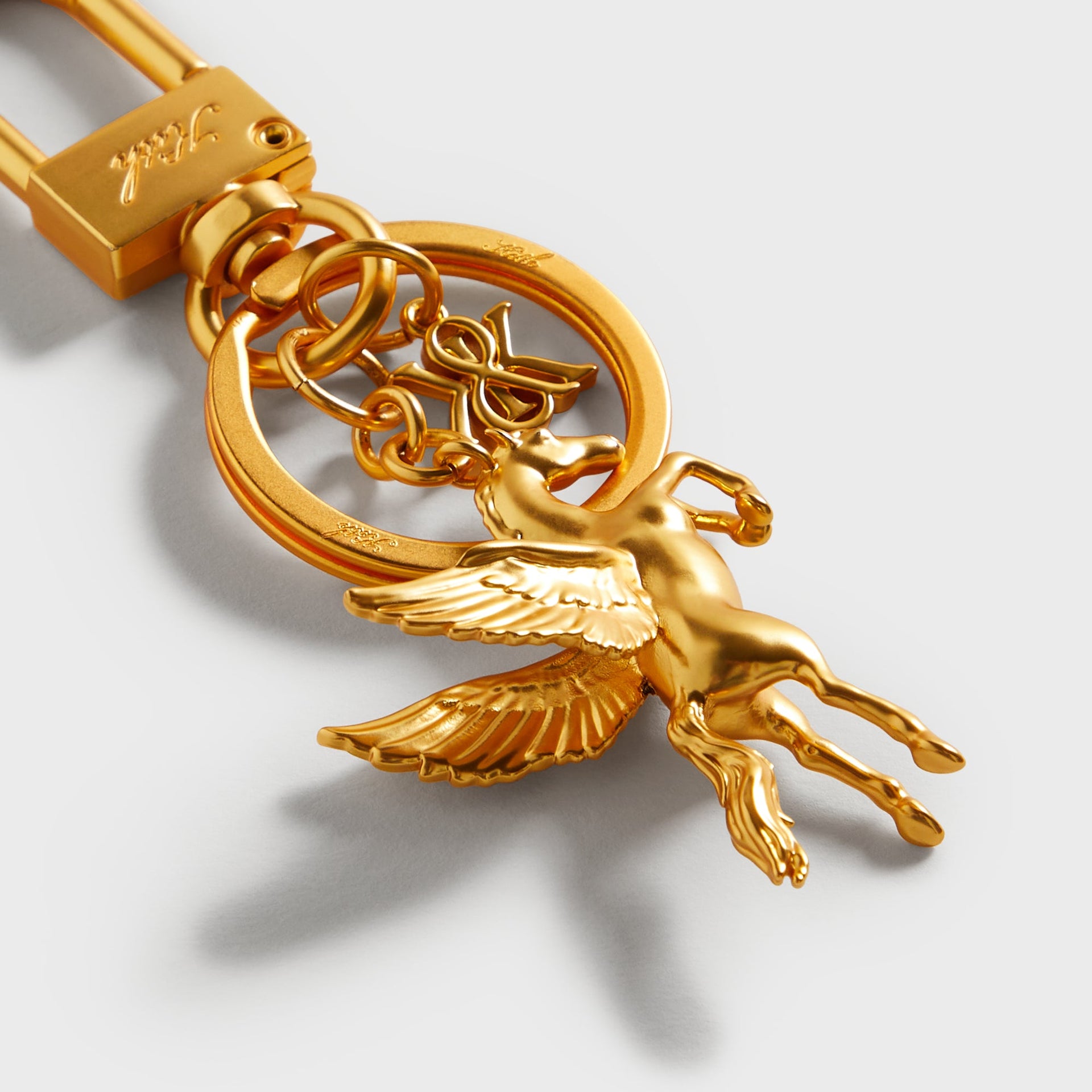 Close-up detail of the Kith Pegasus Keyring in Gold showing the winged horse charm and chain links