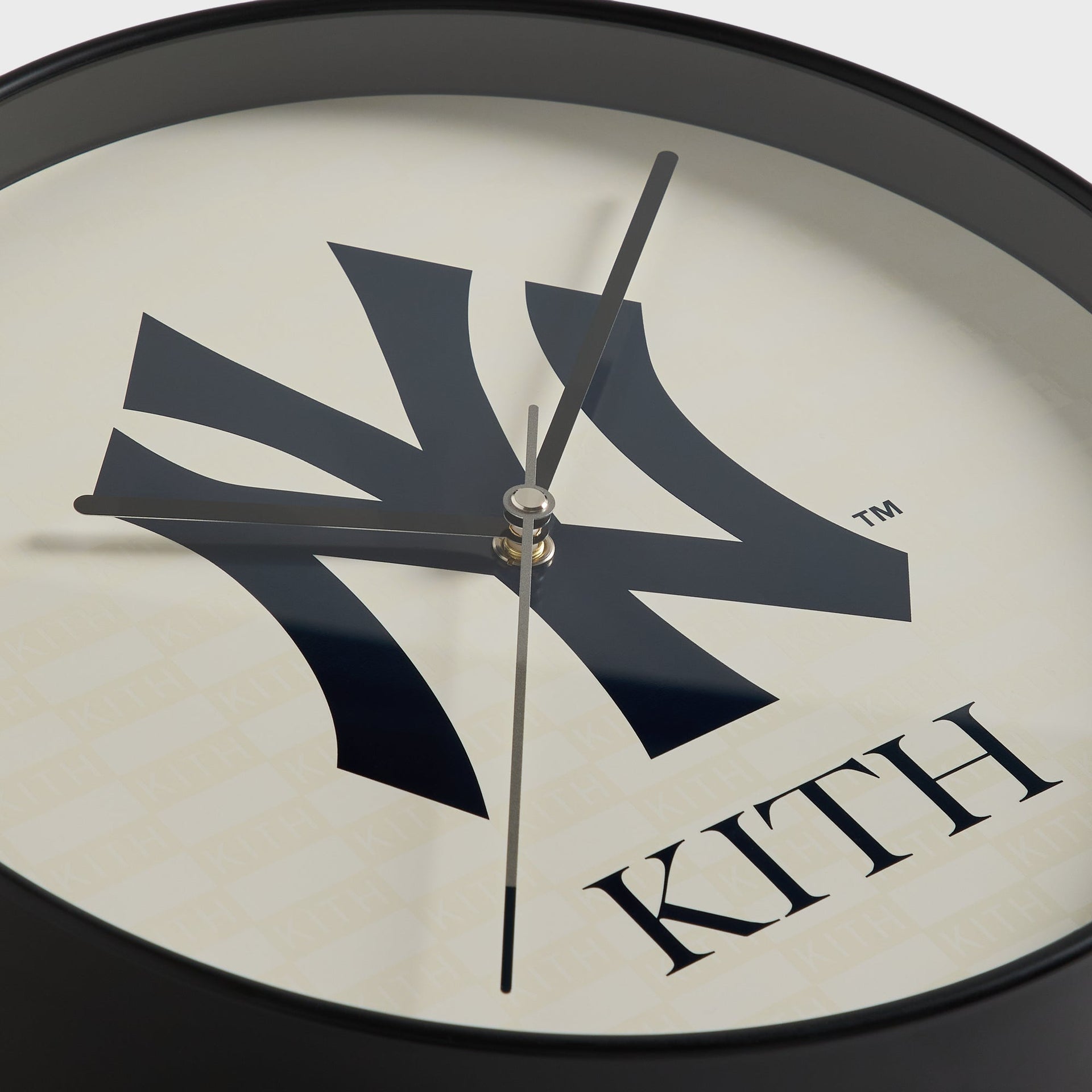 Close-up of clock hands and NY logo face on the Kith x Yankees wall clock