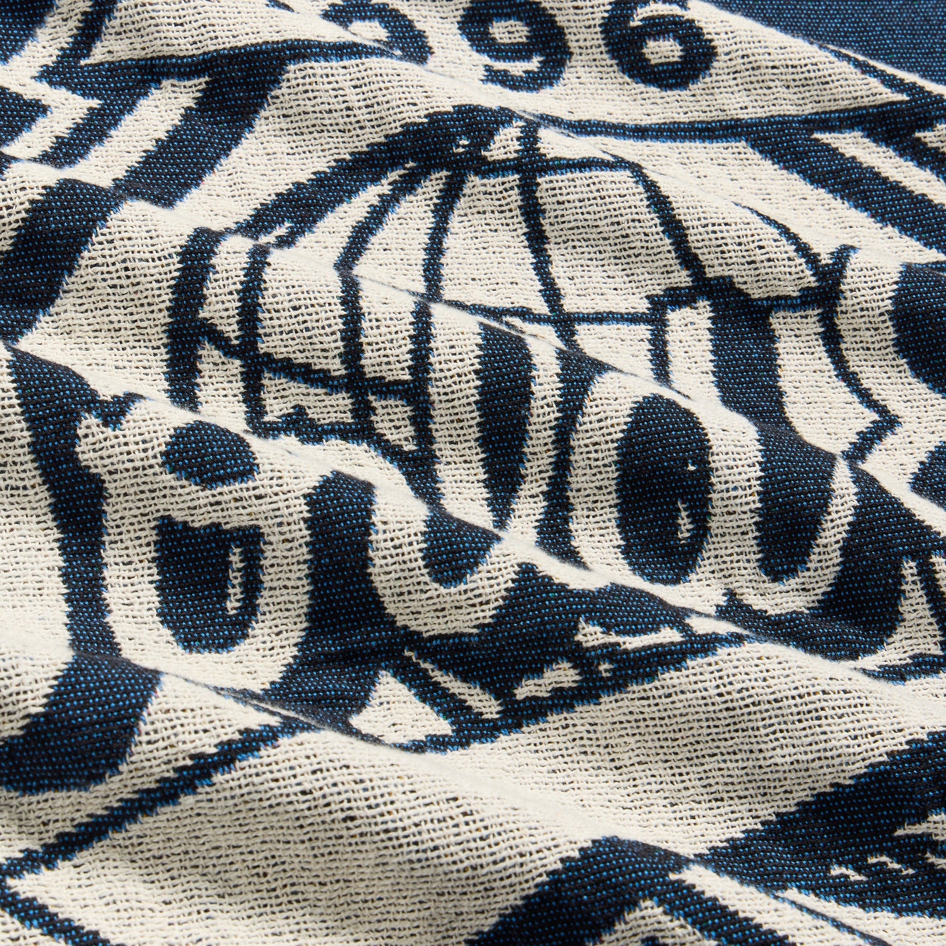 Close-up of woven 1996 World Series globe emblem on the Nocturnal tapestry blanket