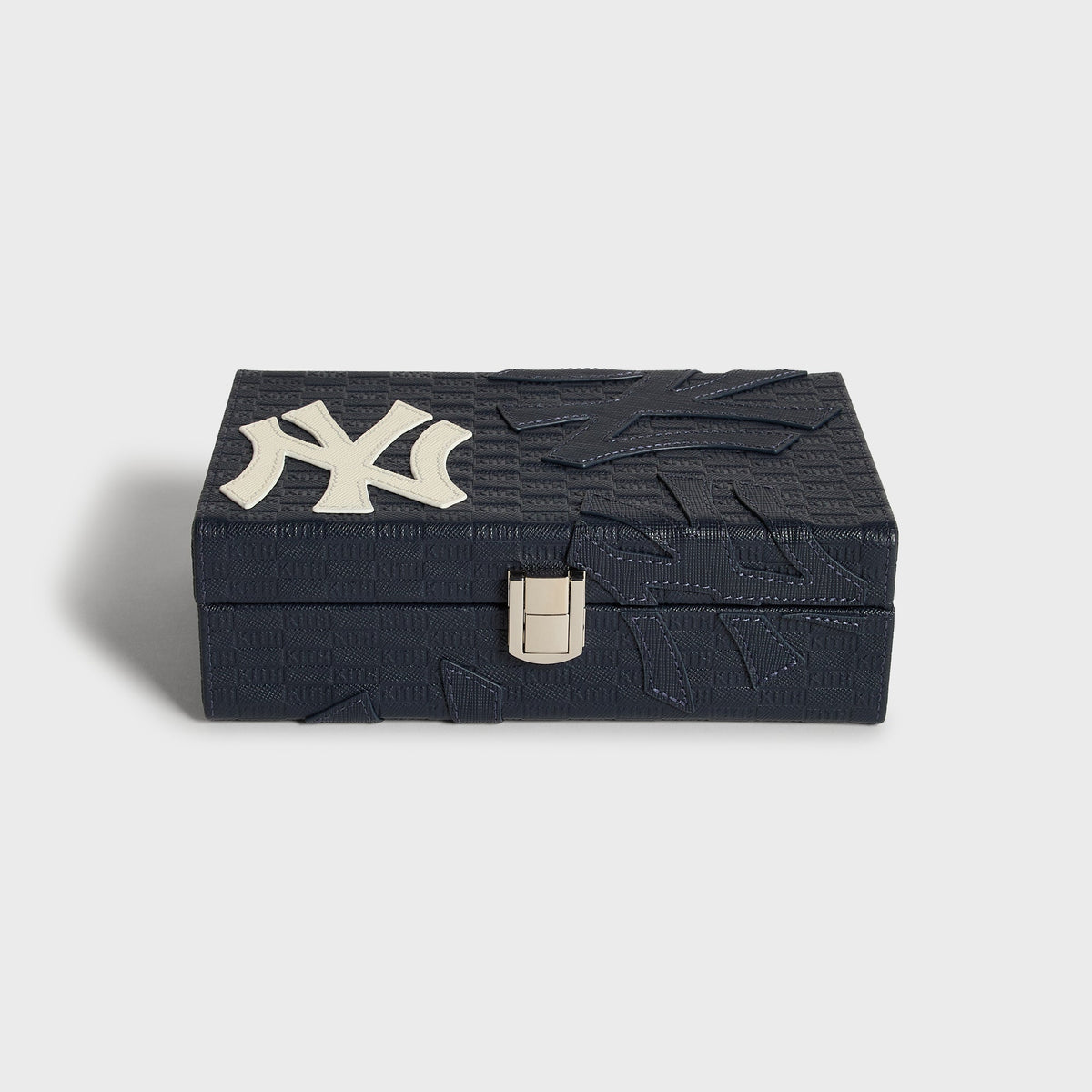 Two Kith x New York Yankees domino tiles standing upright, showing the navy pinstriped back design