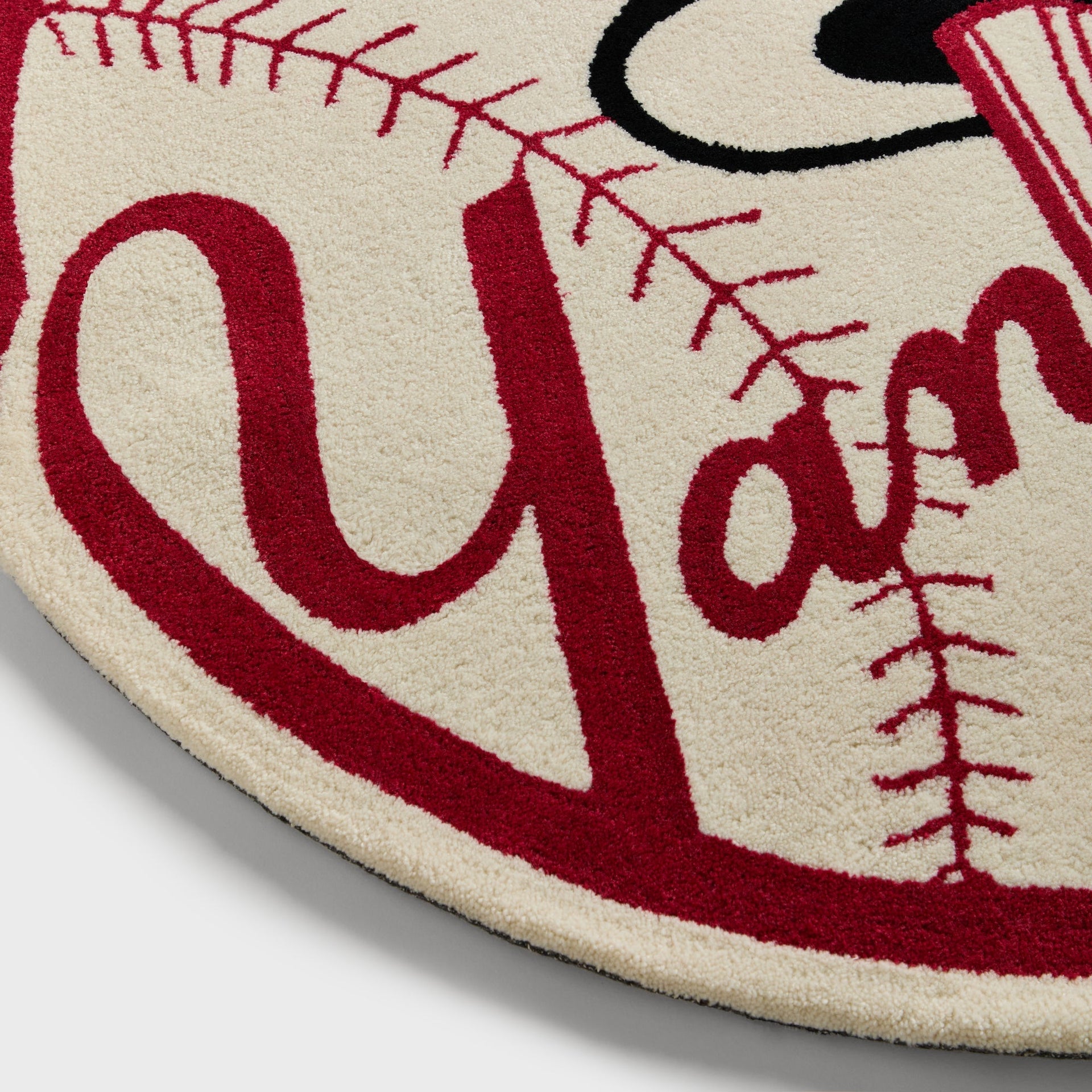 Close-up of the tufted Yankees script lettering and baseball stitching texture on the rug